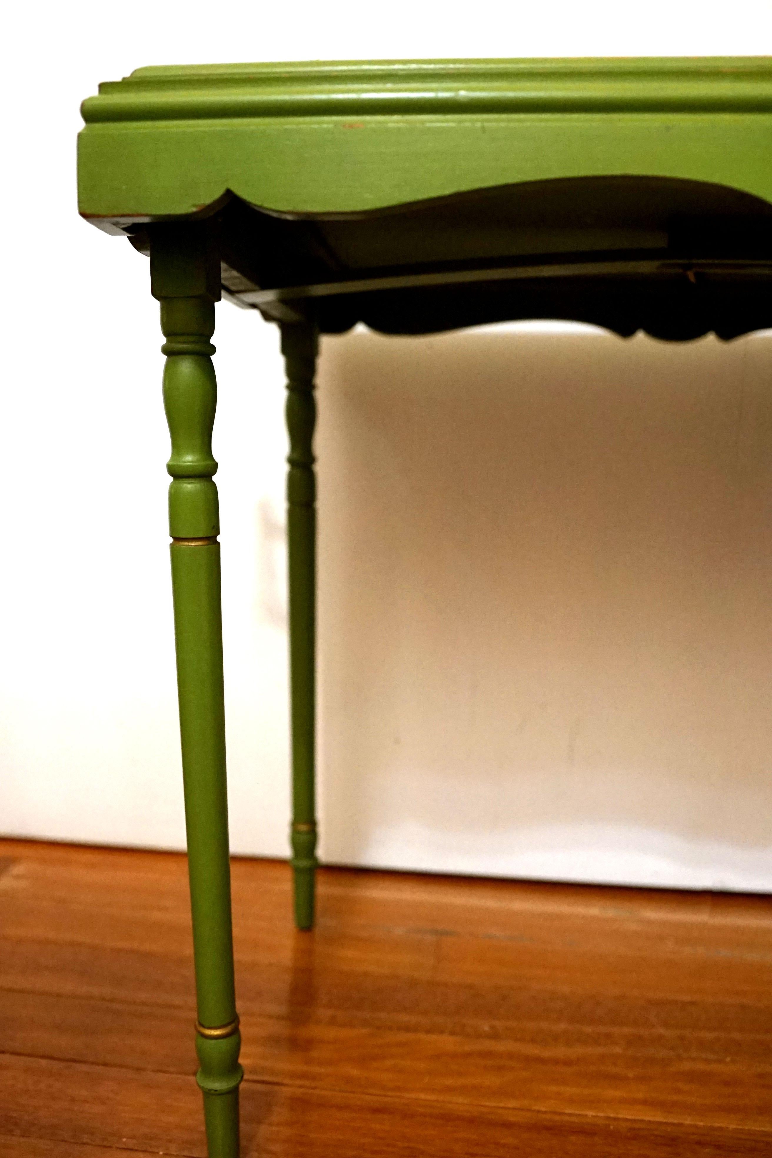 The beautiful pop of color is only part of the attraction with this vintage chartreuse or green painted and parcel gilt collapsible tray table. The tray legs and the folding mechanism work perfectly. 
It was made by Ferguson Bros Manufacturing Co.,