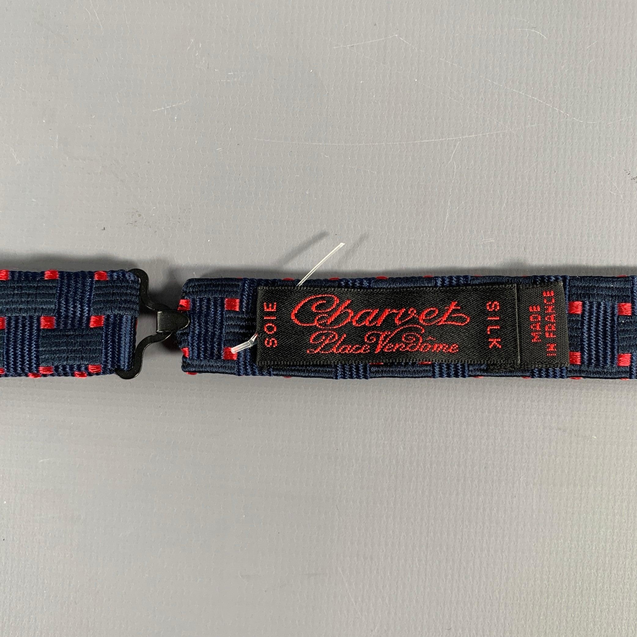 CHARVET bowtie in a navy silk fabric featuring a woven pattern with red squares. Made in France.Excellent Pre-Owned Condition. 

Measurements: 
  Length: 34.5 inches 

  
  
 
Sui Generis Reference: 130154
Category: Bow Tie
More Details
    
Brand: 