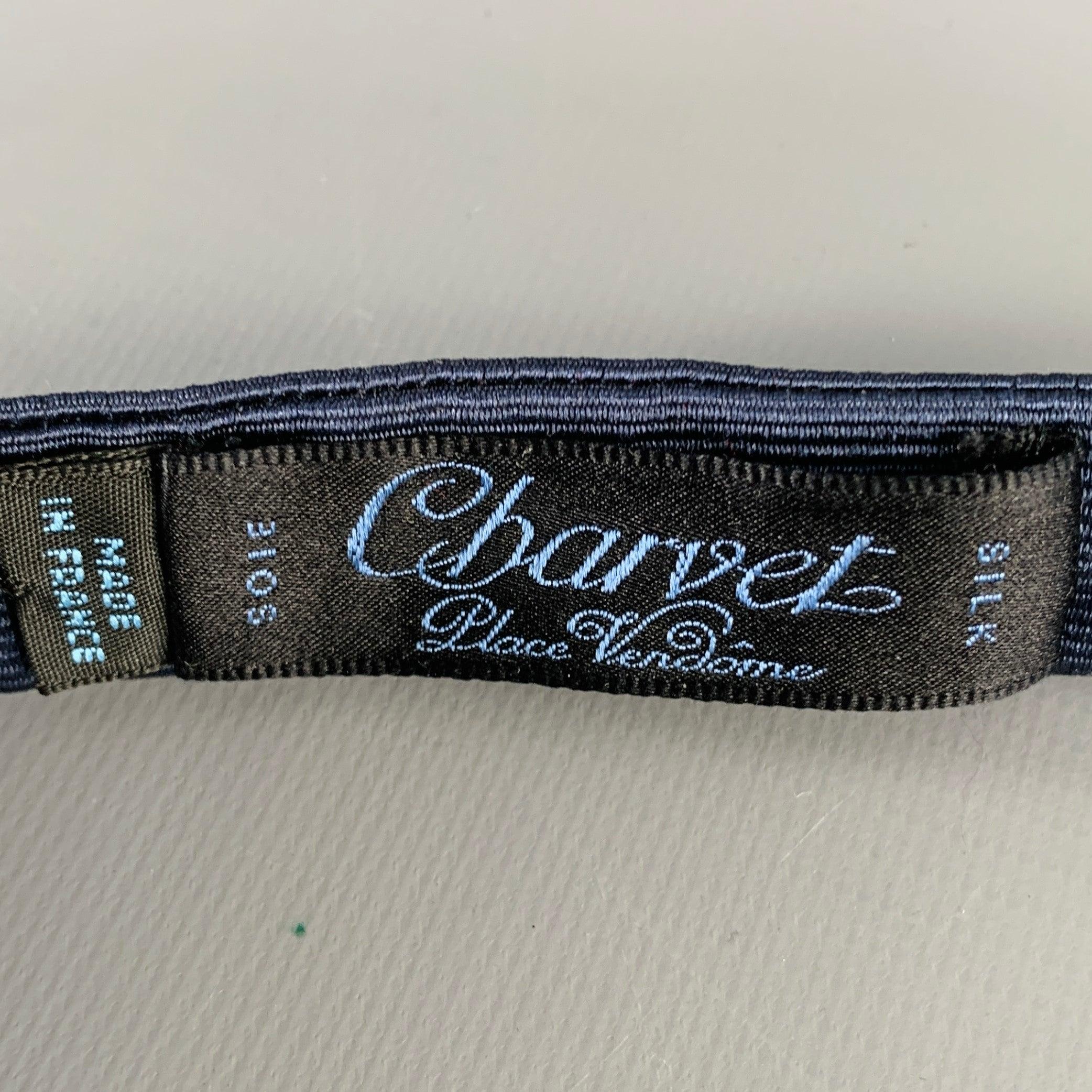CHARVET bowtie in a navy silk fabric featuring a textured stripe design. Made in France.Excellent Pre-Owned Condition. 

Measurements: 
  Width: 2.75 inches  

  
  
 
Sui Generis Reference: 130152
Category: Bow Tie
More Details
    
Brand: 