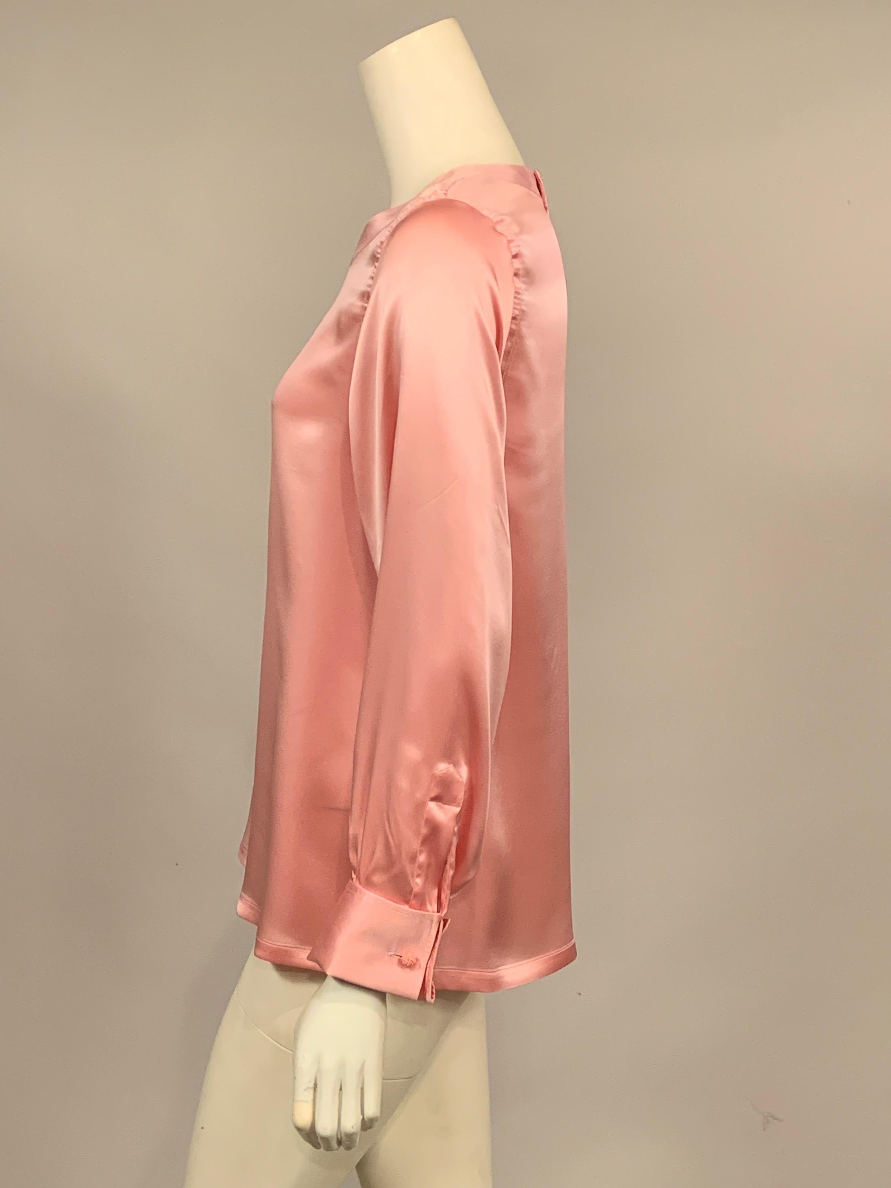 Located on the Place Vendome in Paris, Charvet is famous for shirts and blouses.  This lovely pink silk blouse has a band neckline, long sleeves with French cuffs and pink braid cufflinks, a straight hem with slits on each side so it can be worn out