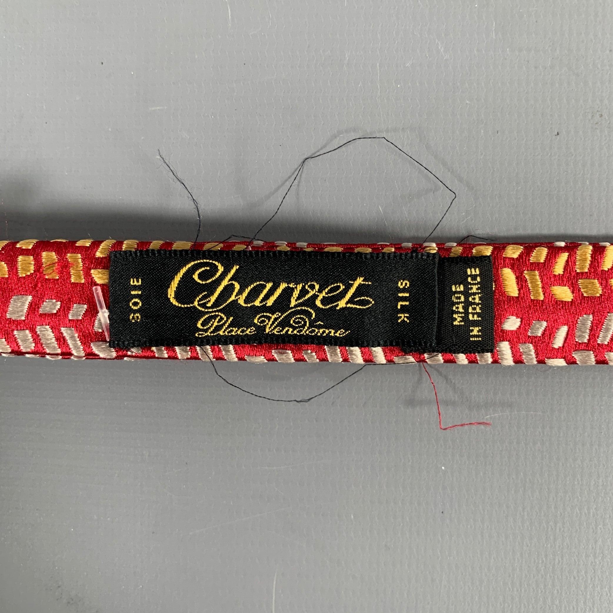 CHARVET bowtie in a red silk fabric featuring a textured red and white abstract design. Made in France.Very Good Pre-Owned Condition. Moderate signs of wear. 

Measurements: 
  Length: 34.5 inches  

  
  
 
Sui Generis Reference: 130155
Category: