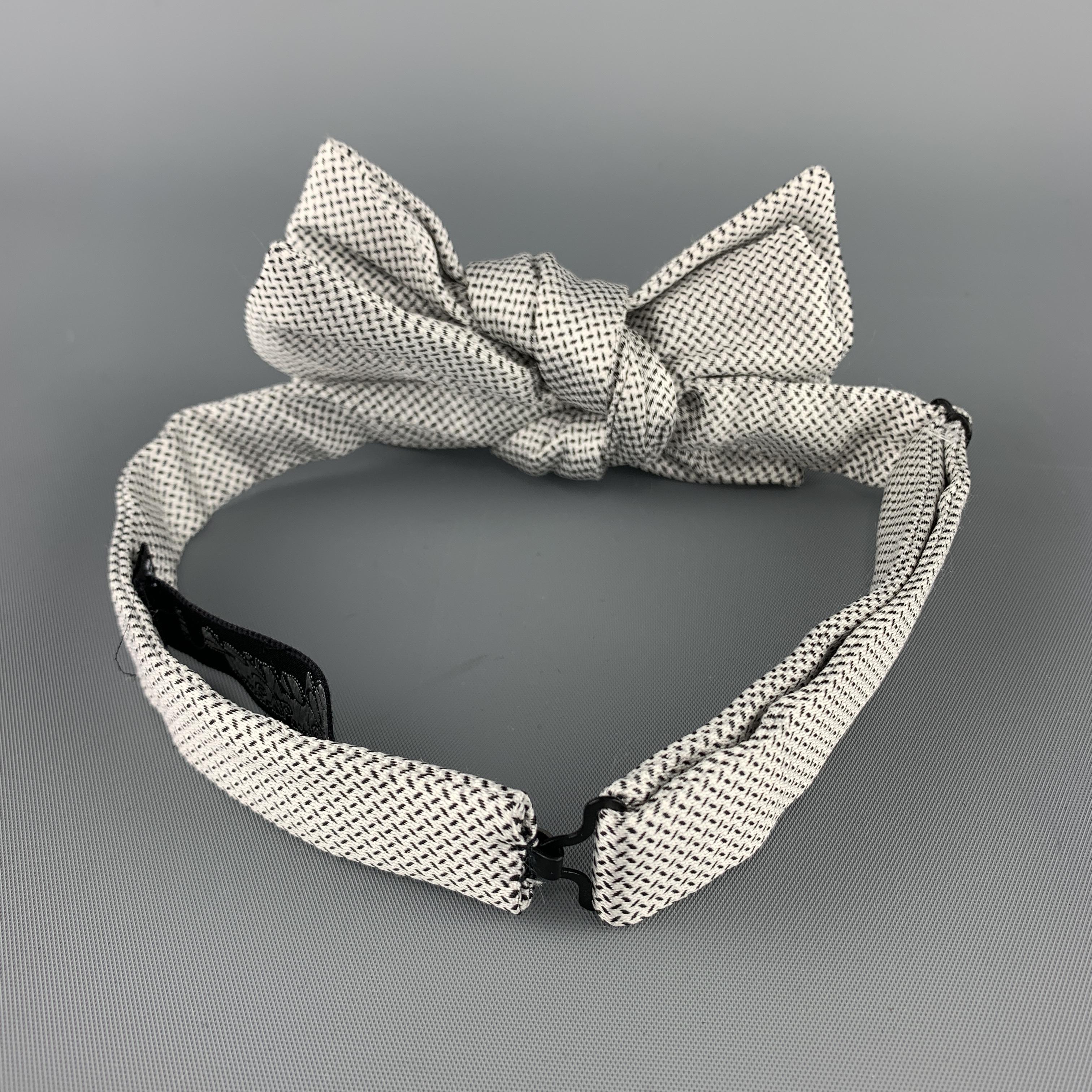 CHARVET bow tie comes in black and white print silk with an adjustable neck. Made in France.

Excellent Pre-Owned Condition. 

Original Retail Price: $250.00