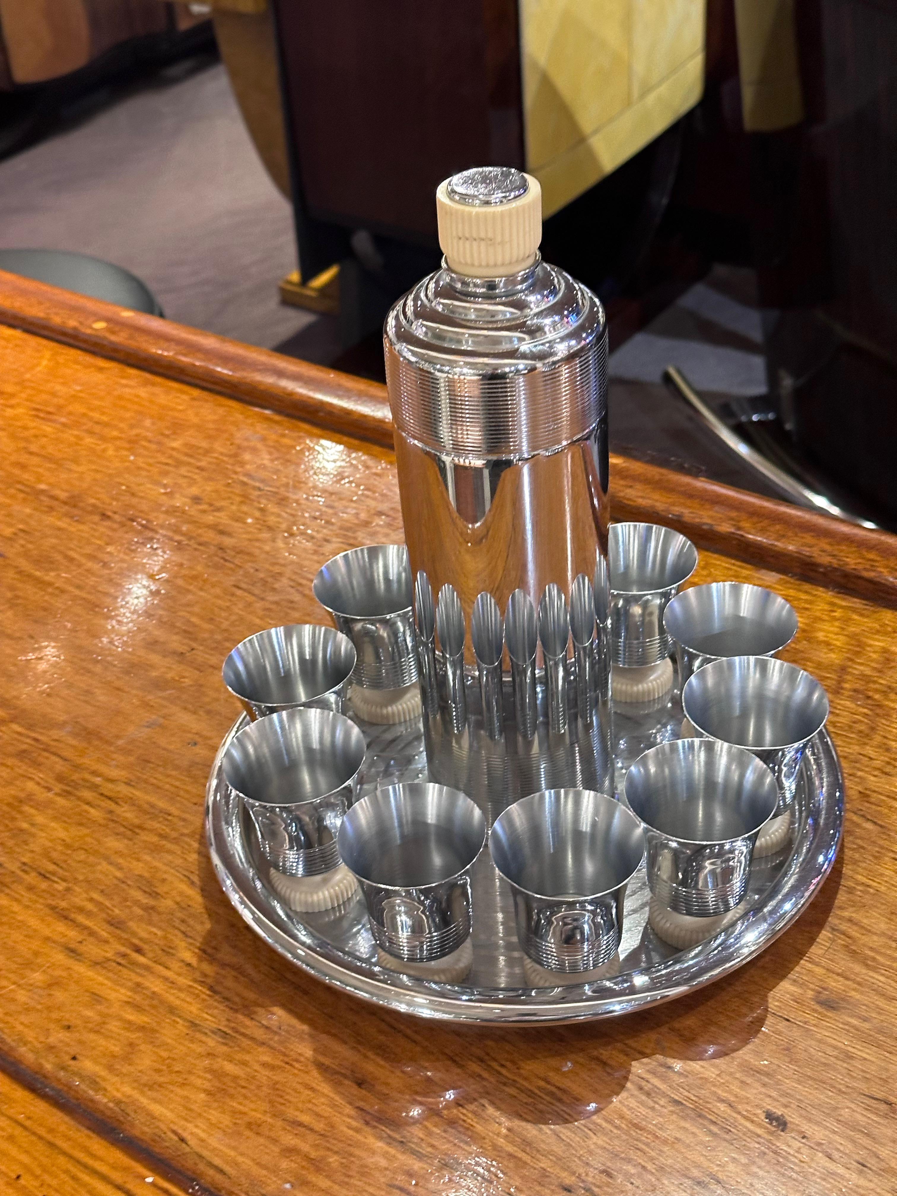 This exquisite Chase White Doric Cocktail Shaker set, a true embodiment of the glamorous Art Deco era, is a collector’s dream. Crafted in the 1930s by the esteemed Chase Brass & Copper Company, this 12-piece set epitomizes the opulence and