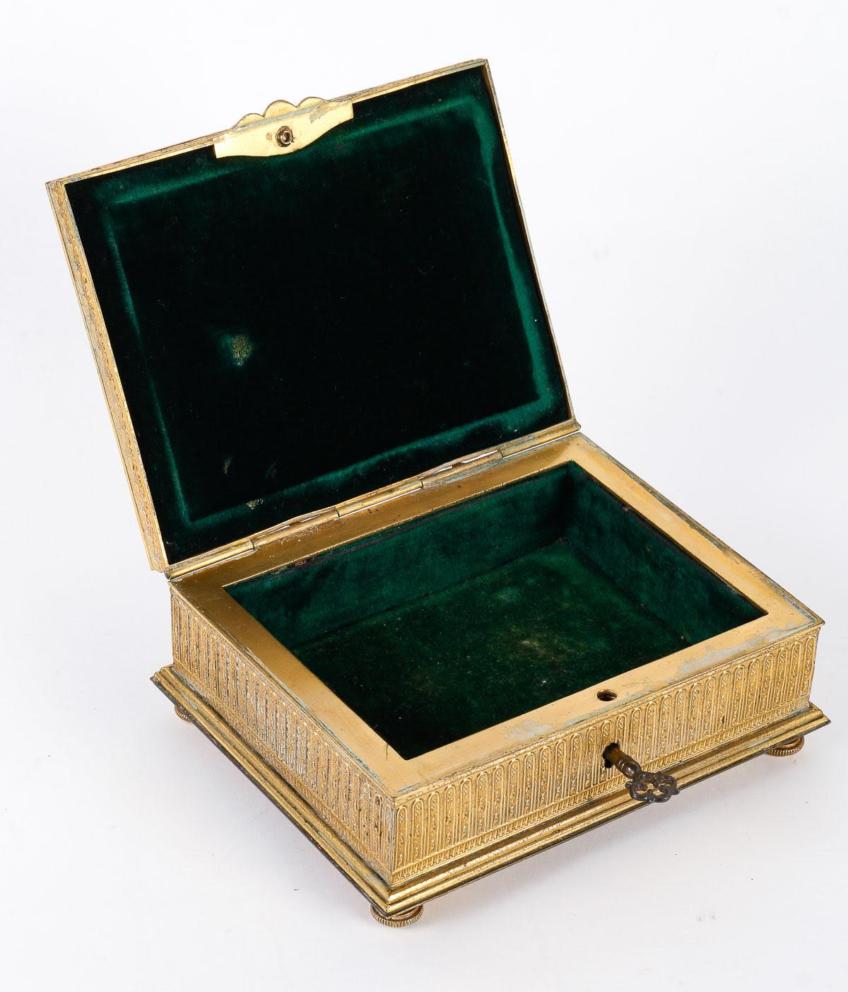 Chased and gilt bronze box, Napoleon III period.

Chased and gilt bronze box with a nice enamel plaque, green velvet interior, with its original key, Napoleon III period, 19th Century.
H: 5cm, W: 15.5cm, D: 12.5cm