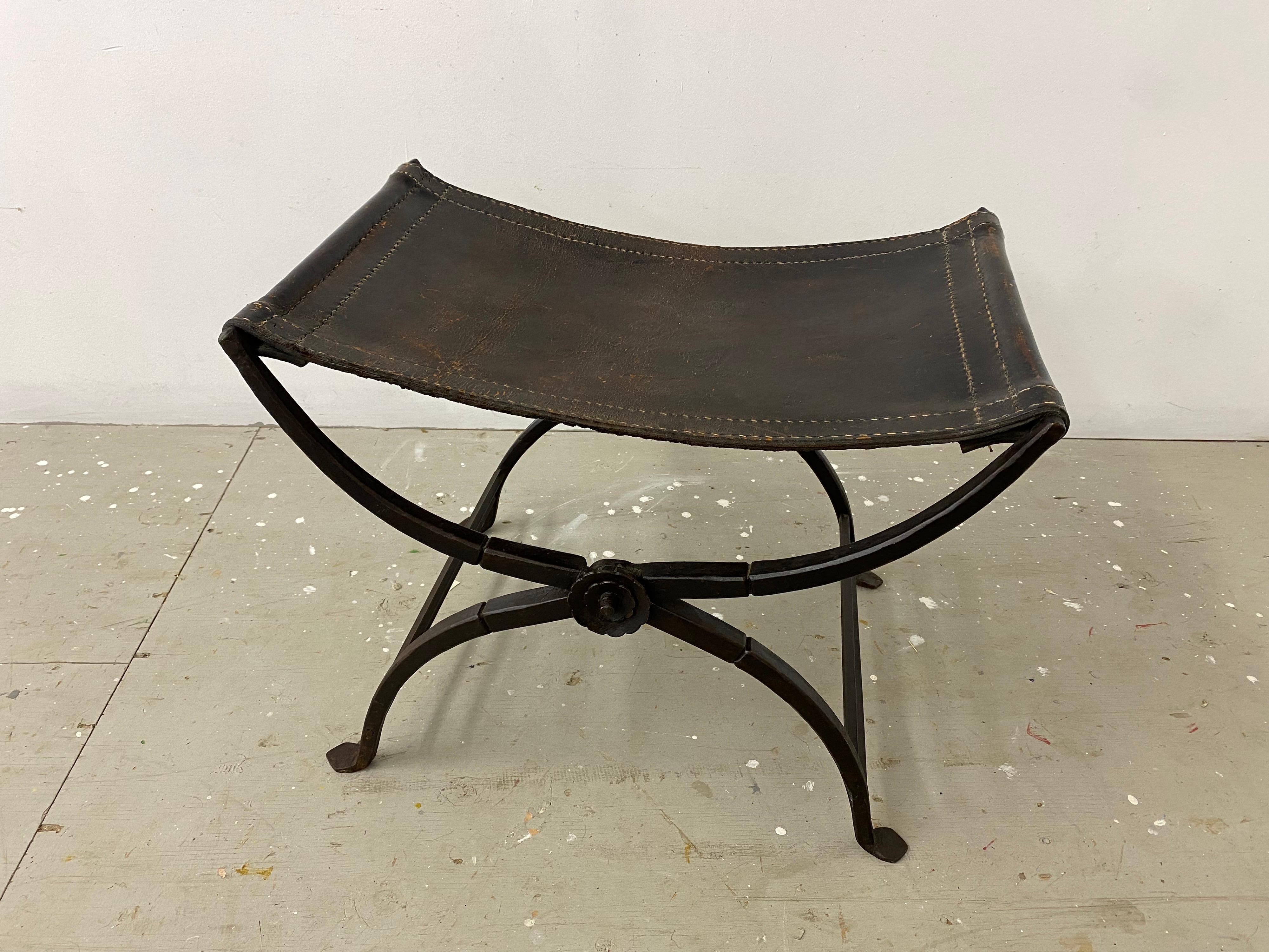 Hand-Forged Iron with Stitched Saddle leather makes this Curule Stool a Classic Roman Form! Curule Stools have been re-imagined and embellished since the Romans first introduced this Classic Form. This Folding Stool with Rosettes on both sides is