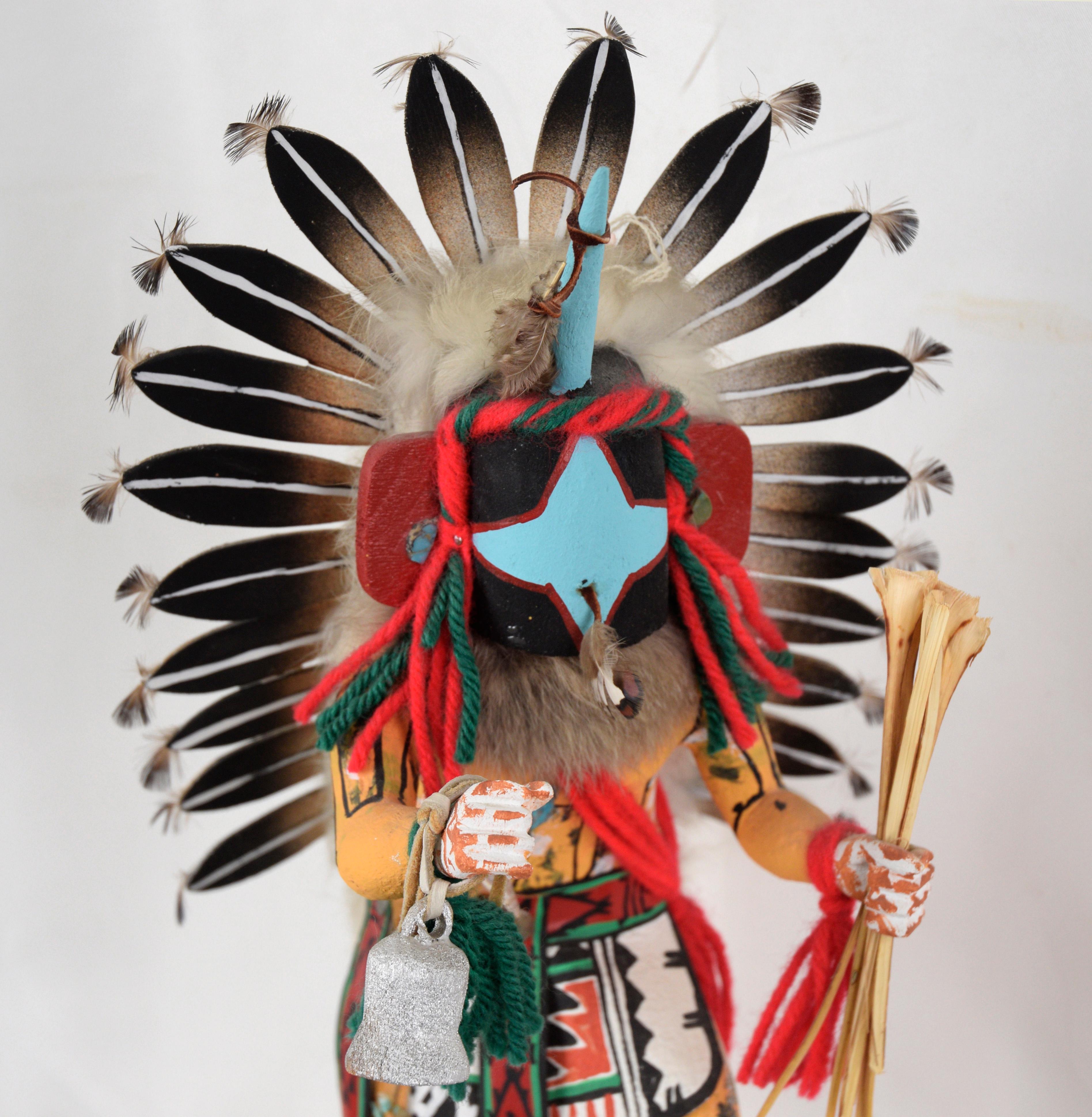 Chasing Star Performing a Dance - Kachina Doll by Rena Jean (Whitehorse)

Brightly painted, dynamic sculpture by Rena W. Jean ( Rena Whitehorse Jean) Hopi. The figure is dressed in ornate clothing, holding a bell and a bundle of yucca sticks. There