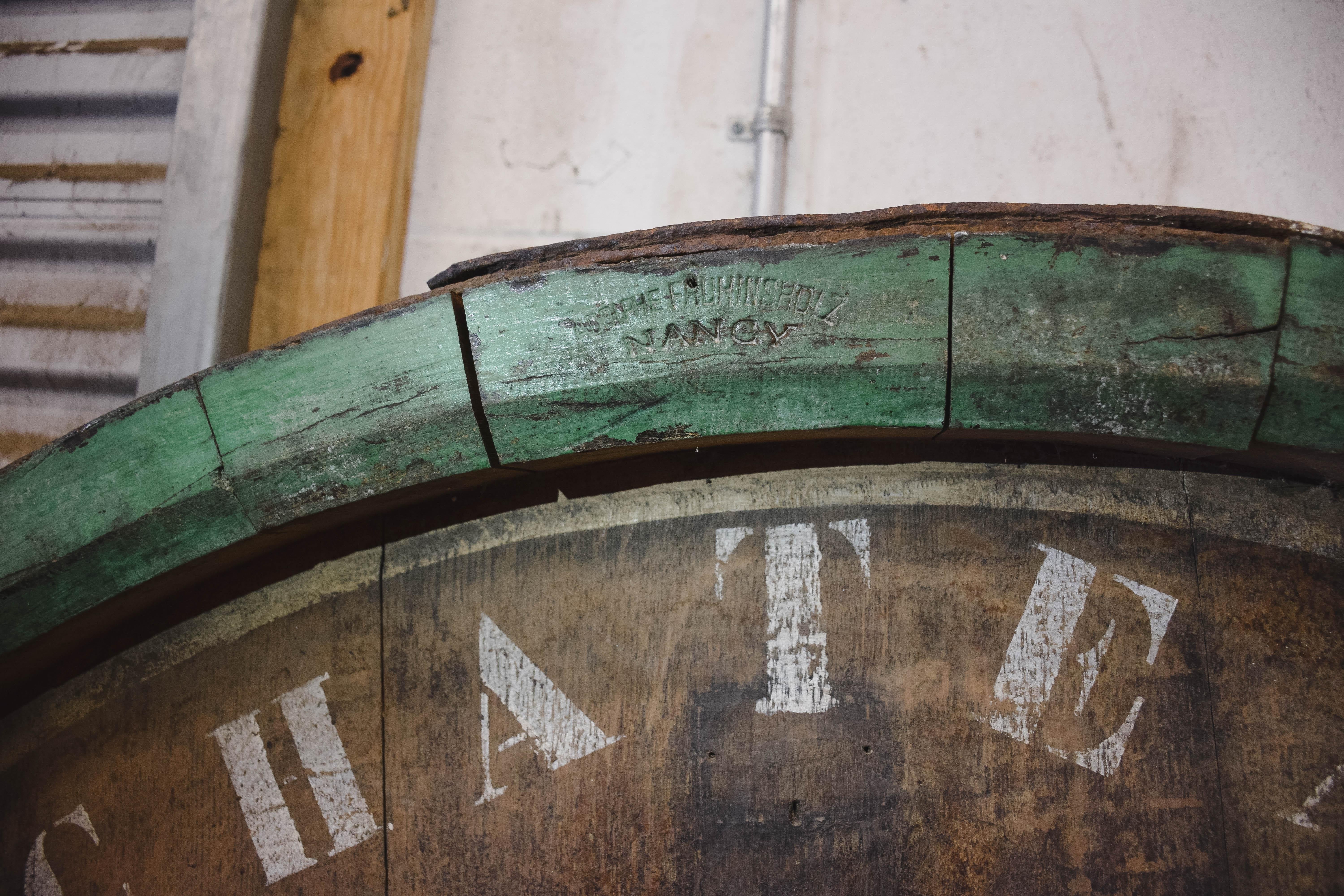 Imported from France, this oversized wine barrel top is from Château Mouton Rothschild Bordeaux and is dated 1926. The barrel is solid oak and iron and is stamped by the specialist barrel maker Adolph Fruninsholz Nancy. At the top of the barrel