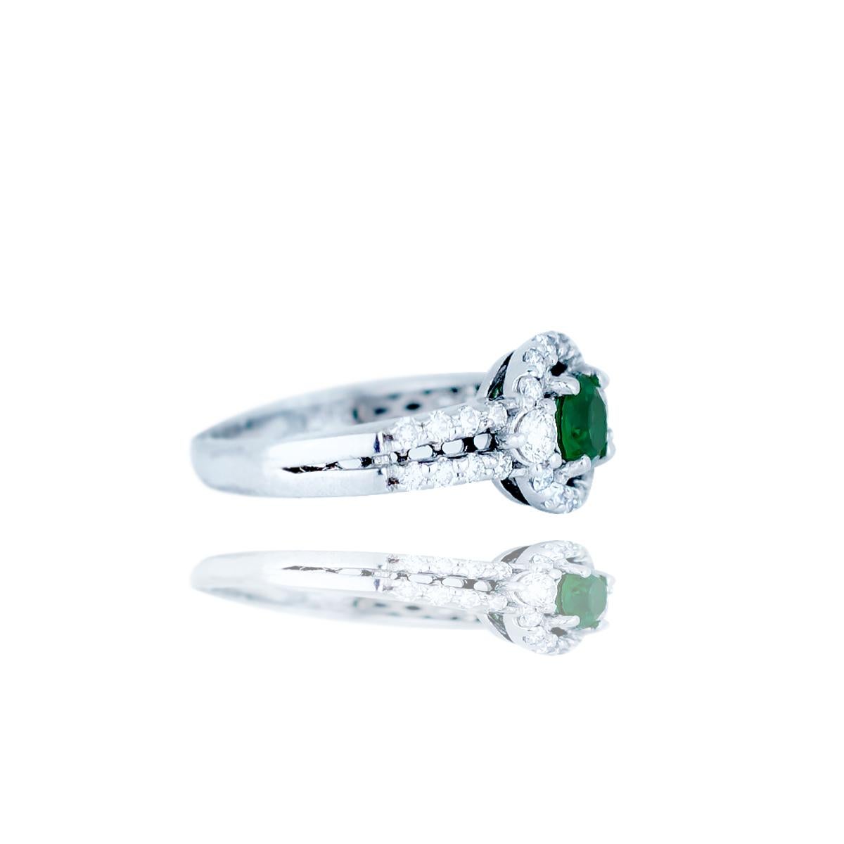 Chatham Emerald set with Diamonds in Halo Diamond Ring, 1.25TCW 
Round Shaped, measures 5.40 mm and is a deep colored Chatham Emerald stone weighing approximately .50 carat 
The rings diamonds are 1.8-3.2 mm each with a total weight of estimated .75