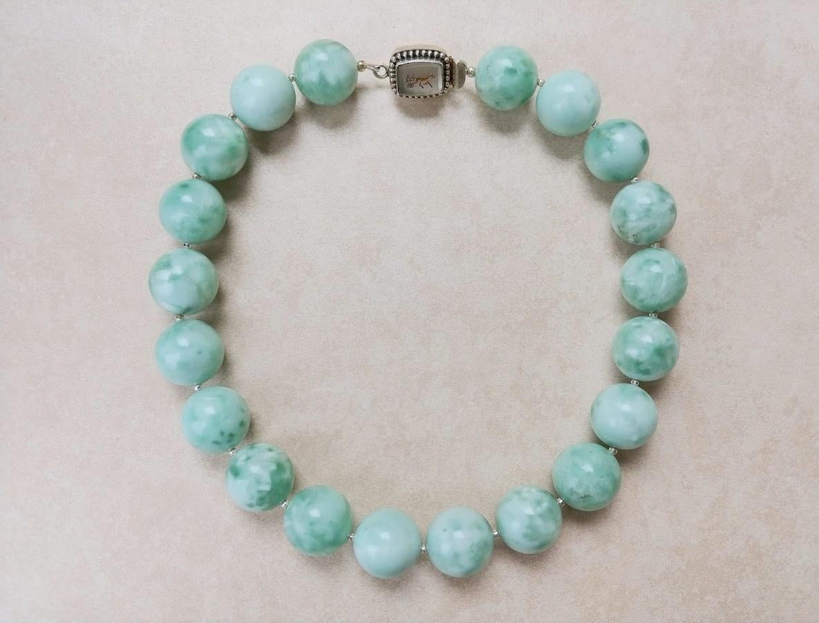 The length of the necklace is 18 inches (45.7cm). The rare size of smooth round beads is 20 mm.
Angelite color is non-uniform and can change its tone at different angles. Beads have delightfully soft pastel green tones with silk effect and