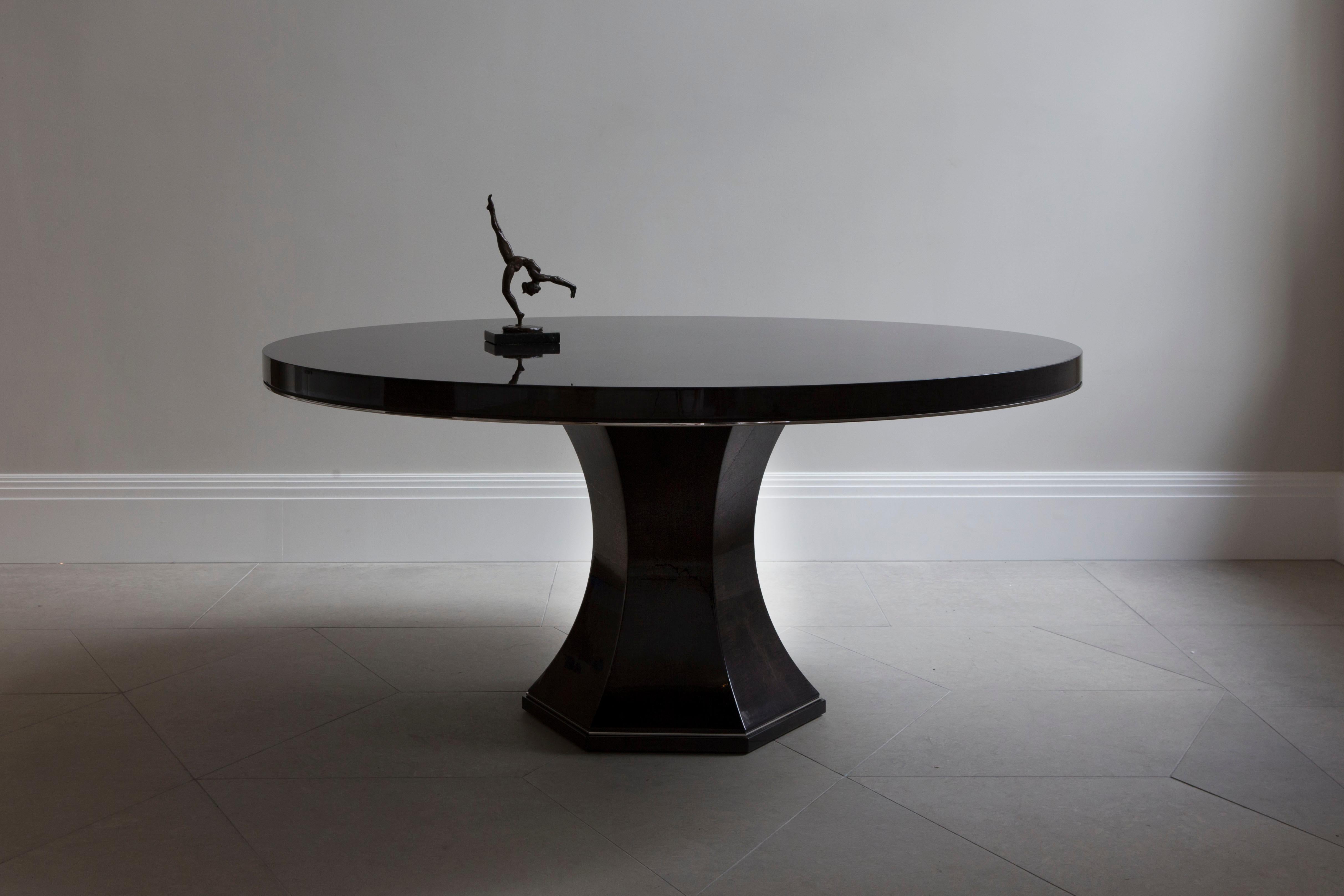 An elegant dining or centre table finished in high gloss sycamore black with brushed brass detailing.

A classic design with a stunning radial pattern to the table top, smart brushed brass mouldings and a smooth hexagonal base. This design is an