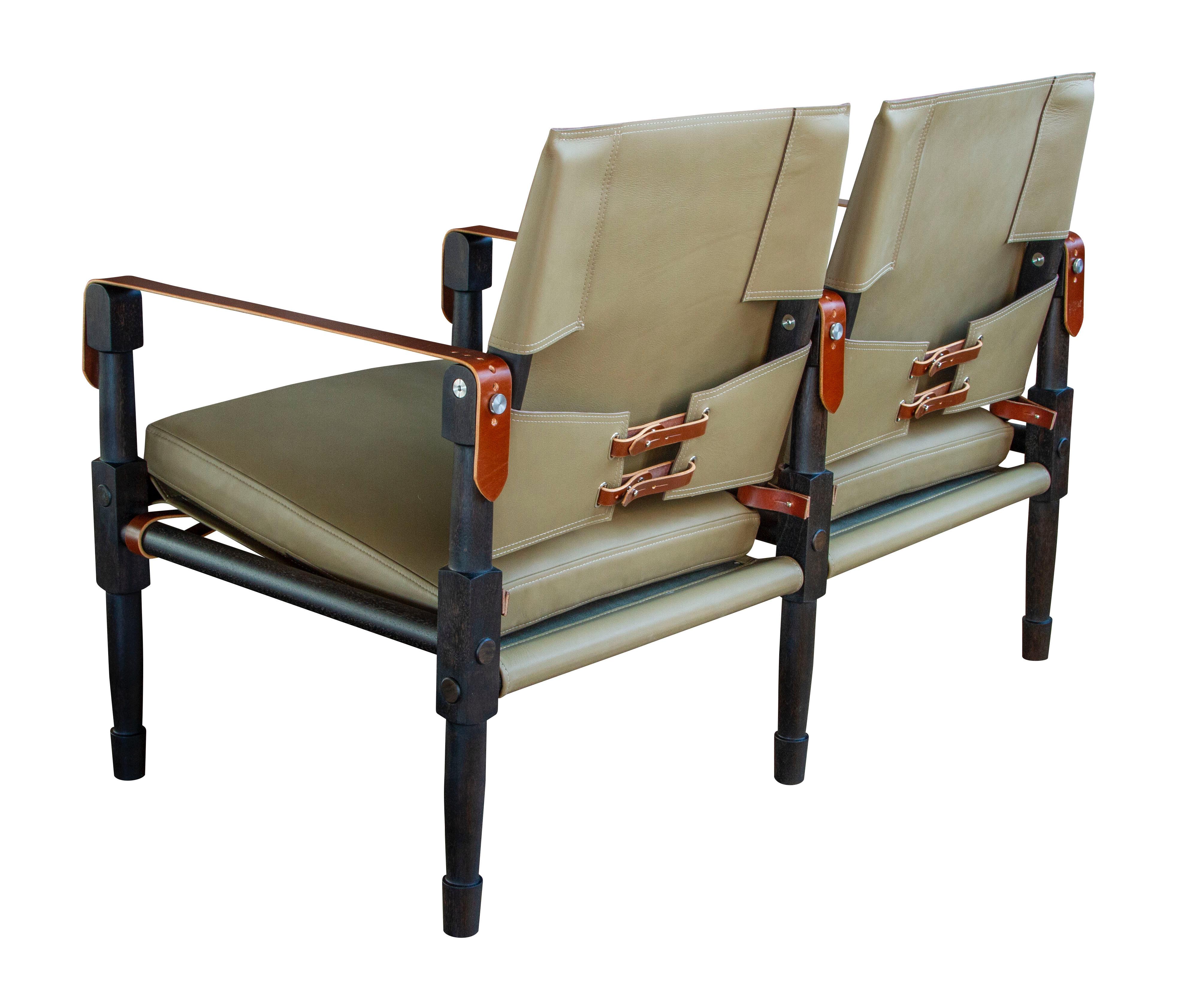 The Chatwin lounge settee in ebonized walnut with Cortina olive leather and Havana English bridle leather strapping.

The modern campaign collection by Richard Wrightman combines the vernacular of traditional form with a modern aesthetic, mixing