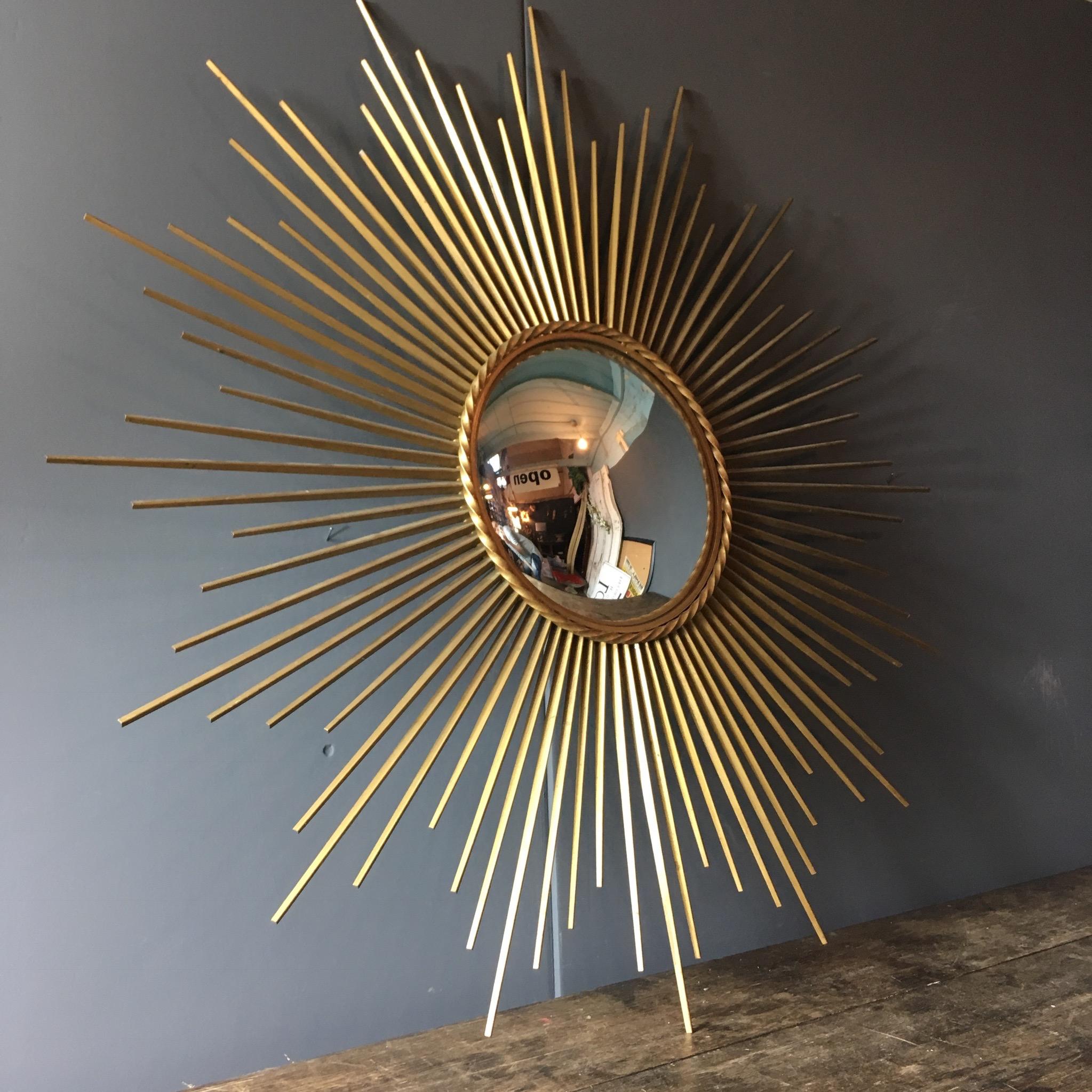 Chaty Vallauris French sunburst mirror

Convex mirror

Gilt metal with twist detail around the mirror 

Stamped with 'Chaty Vallauris' on reverse

Total width 85 cm width
Mirror width 25cm

Hanging hook on reverse

One of the small
