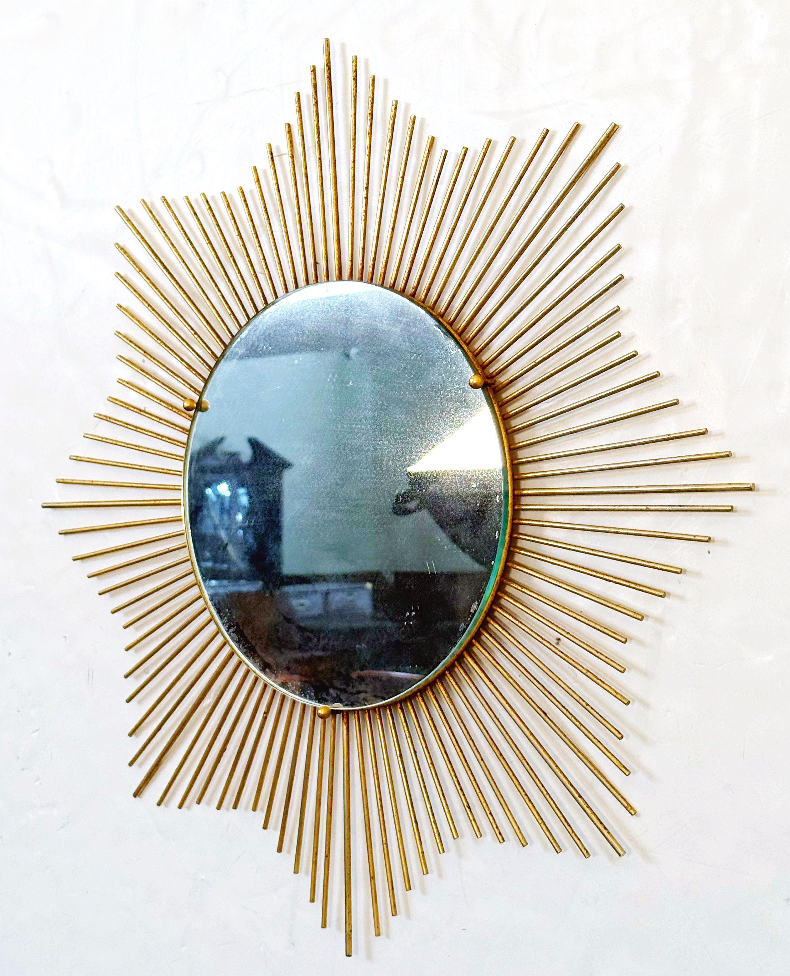 A lovely French sunburst (or starburst) mirror with beautifully made gilt metal rays arranged around the mirror plate glass center, attributable to Chaty Vallauris.  

Diameter 25 3/4 inches

The Chaty Vallauris starburst or sunburst mirror is an