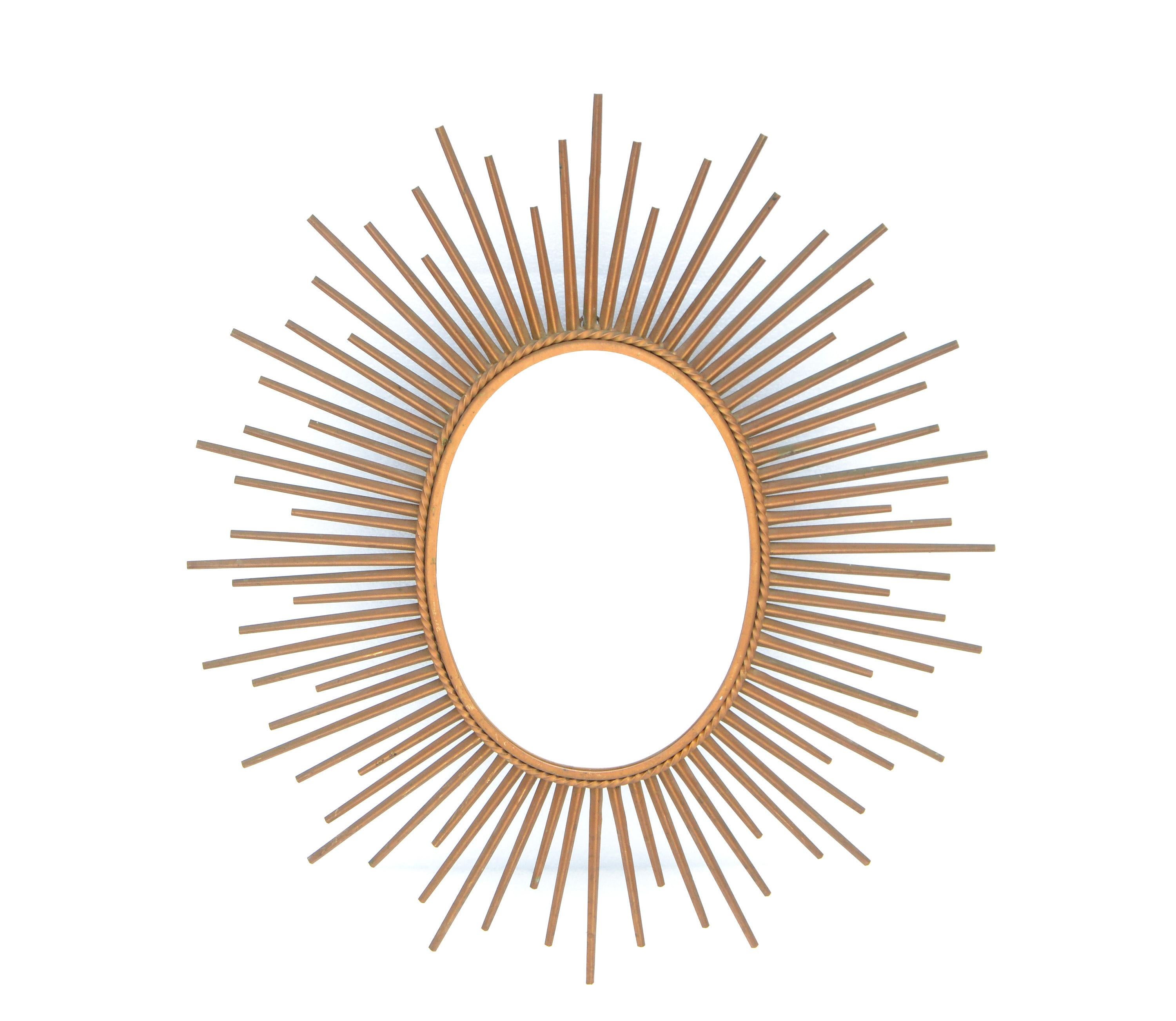 Superb French Mid-Century Modern oval metal sunburst wall mirror in gold finish.
Marked on the reverse Chaty Vallauris, France 1970.
Mirror Size: 10.75 x 7.63 inches. 