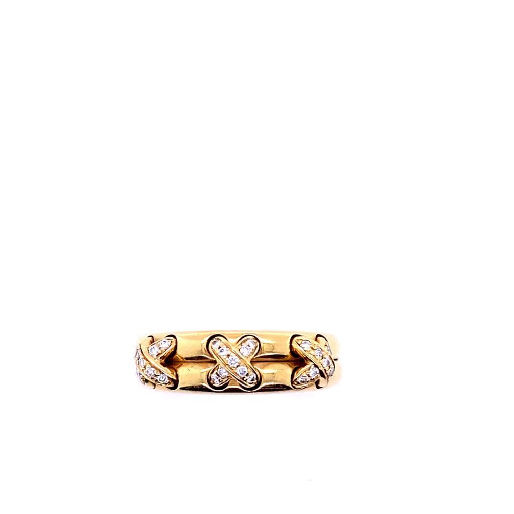 A Chaumet 18 karat yellow gold diamond Liens ring 

This elegant and bold piece is designed as a pleasing double band, with three diamond set crosses to the centre that appear beautifully 'stitched' into each of the gently curved stacked joined