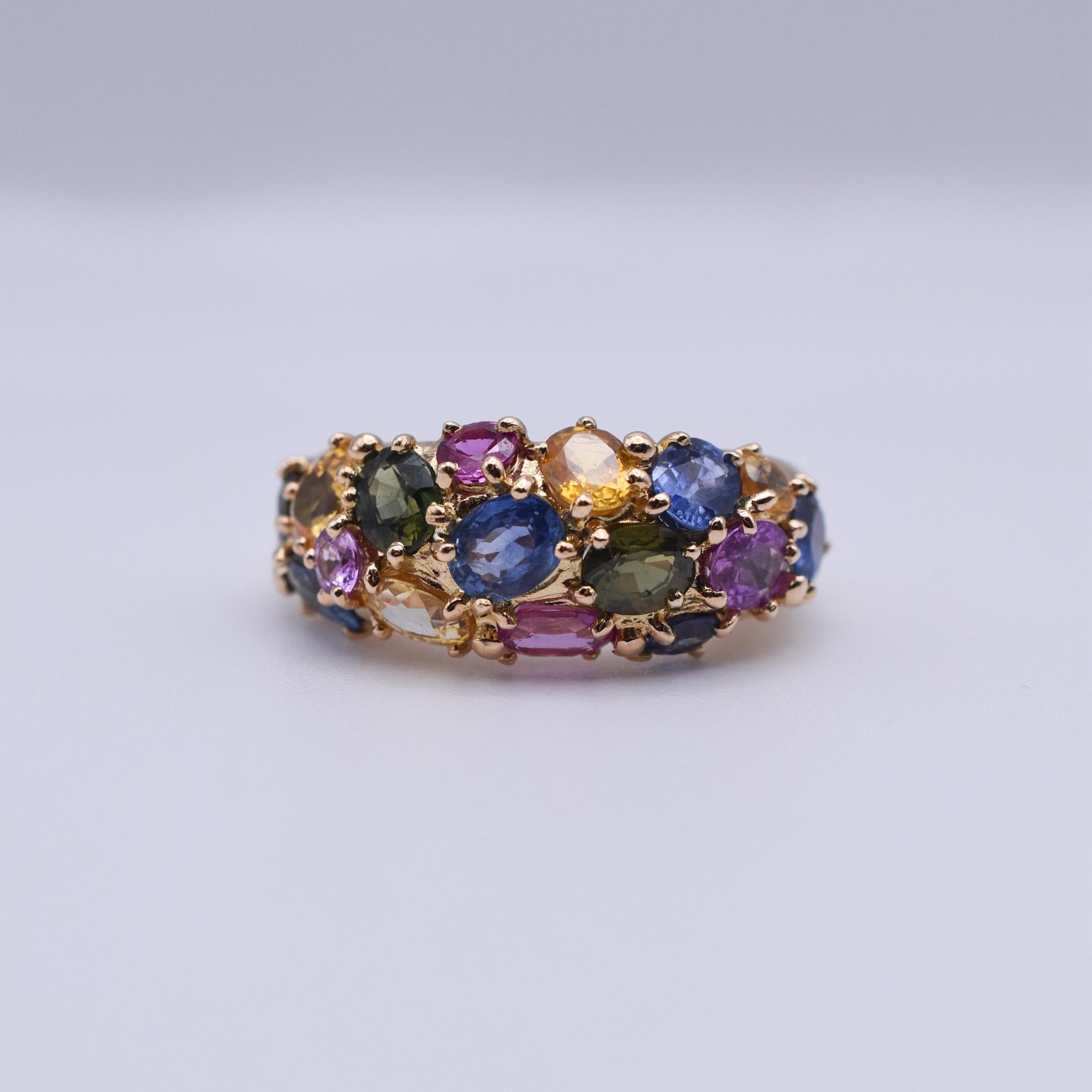 An elegant Chaumet Multi-colour Sapphire Earclips and Ring set mounted on 18k Yellow Gold. Signed Chaumet Paris. Made in Paris, circa 1970. 

Ring size: US 4.75