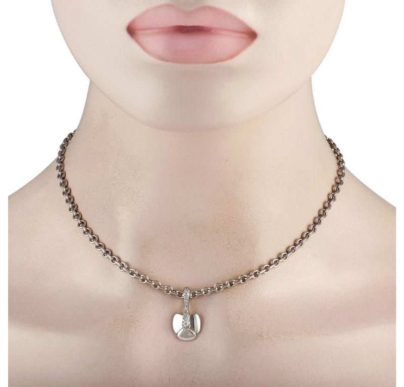 This 18K White Gold Chaumet necklace is poised to put the perfect finishing touch on any upscale ensemble. Suspended from a 16” long chain, you’ll find a delicate diamond-accented pendant that measures 1” long and 0.5” wide. 
 
 This jewelry piece