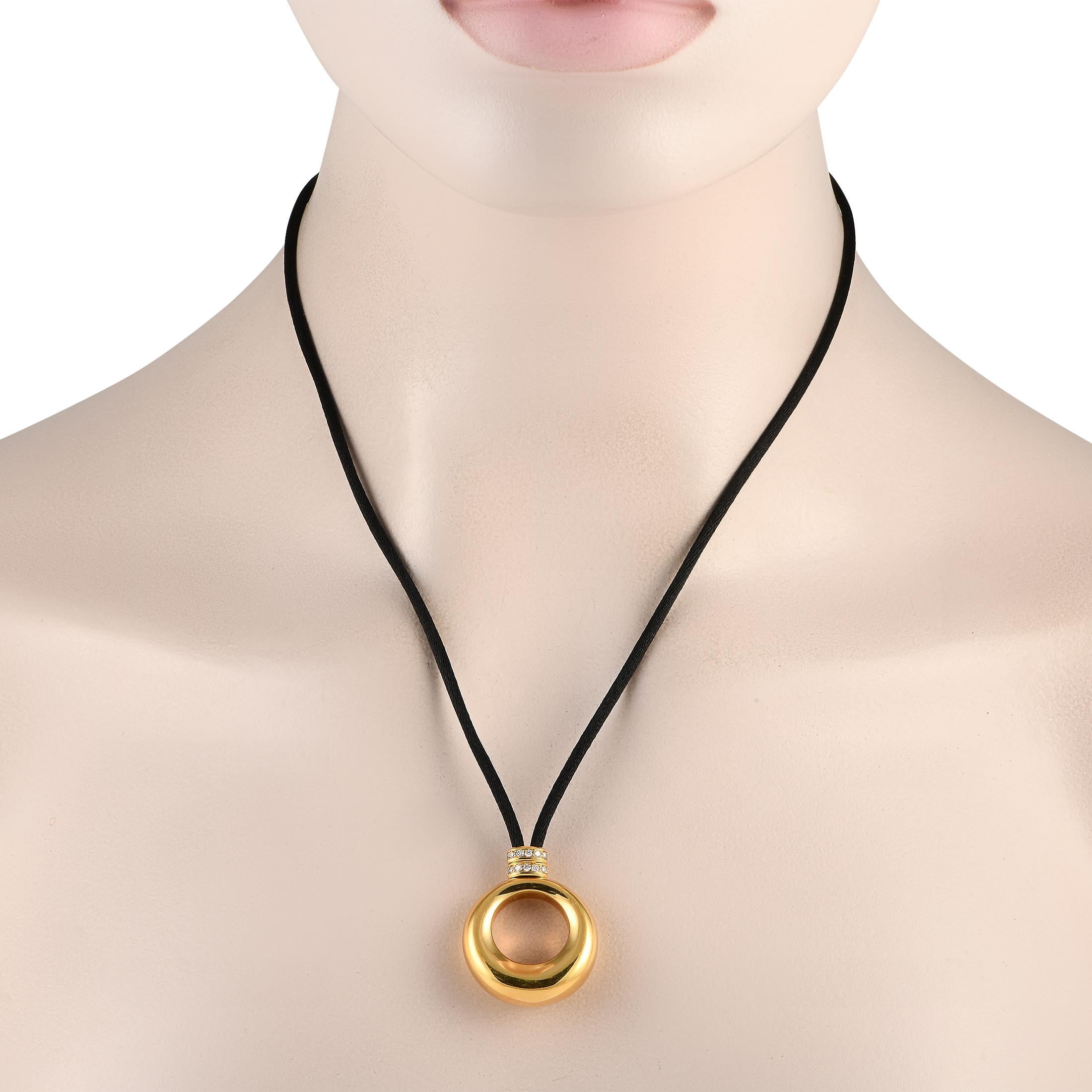 This Chaumet necklace possesses an understated elegance. Suspended from a 30 silk cord, youll find a sleek, sophisticated 18K Yellow Gold pendant measuring 1.45 long by 1.0 wide. Diamond accents at the base of the pendant make it even more