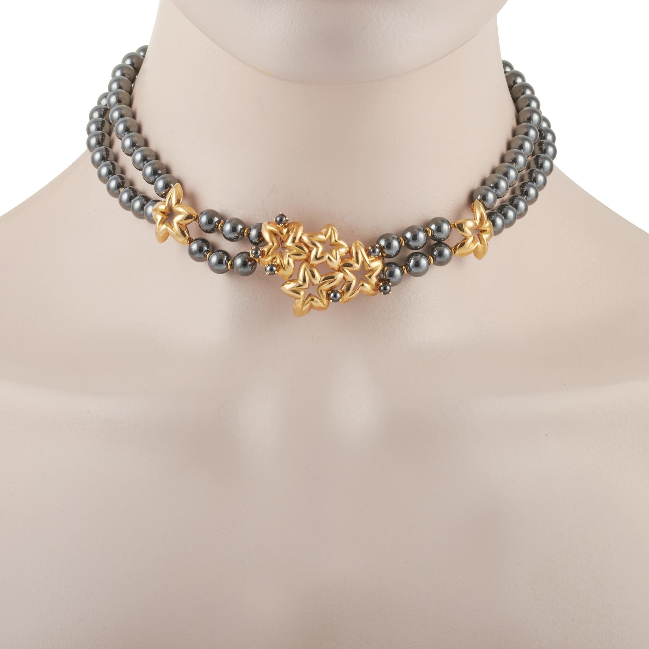 Bold and dramatic, this statement necklace from Chaumet combines the dark and intriguing look of hematite with the striking shine of 18K yellow gold. This jewel features a collar necklace made of hematite beads interspersed with sculpted golden