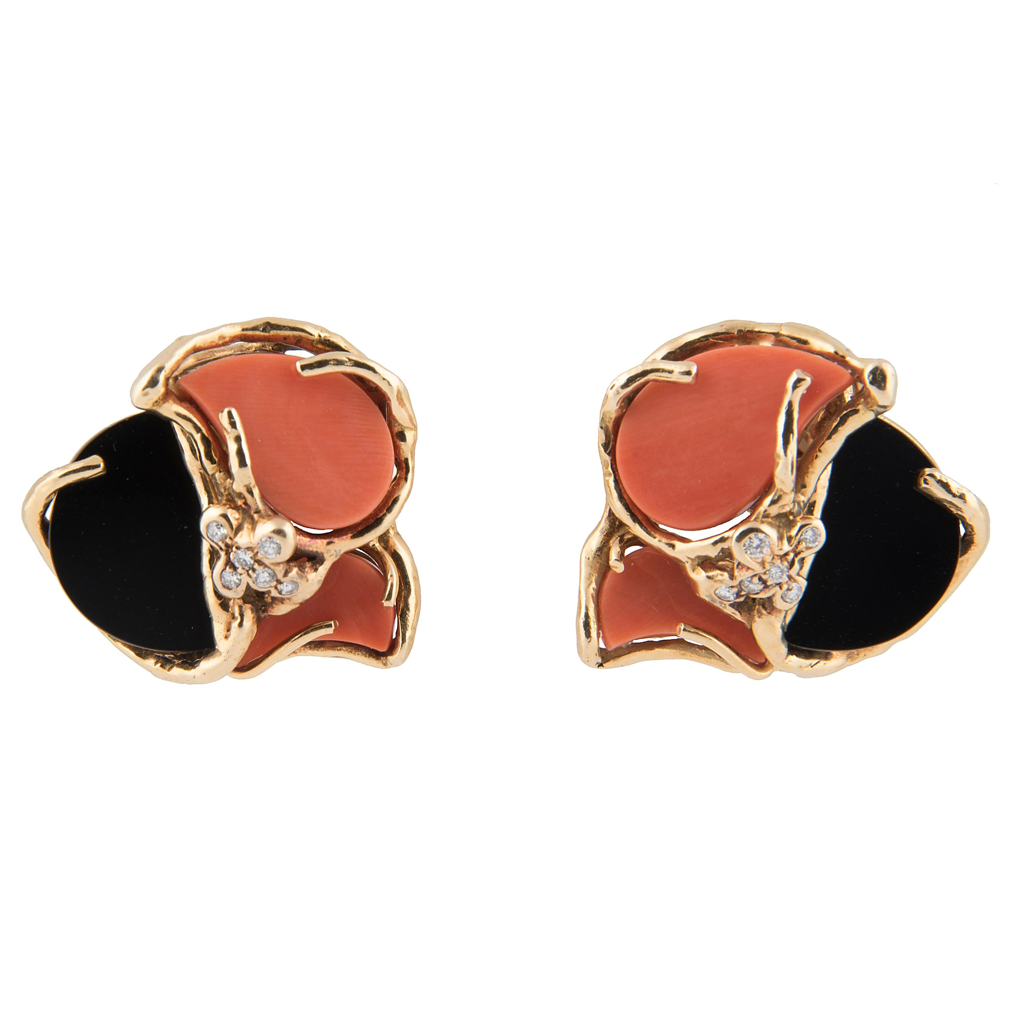 Pair of clip-on earrings by Chaumet, each with one onyx and two coral plaques set in 18k yellow gold mounts set with five diamonds
Signed Chaumet, maker's mark, French hallmarks and numbered 626C
1970's