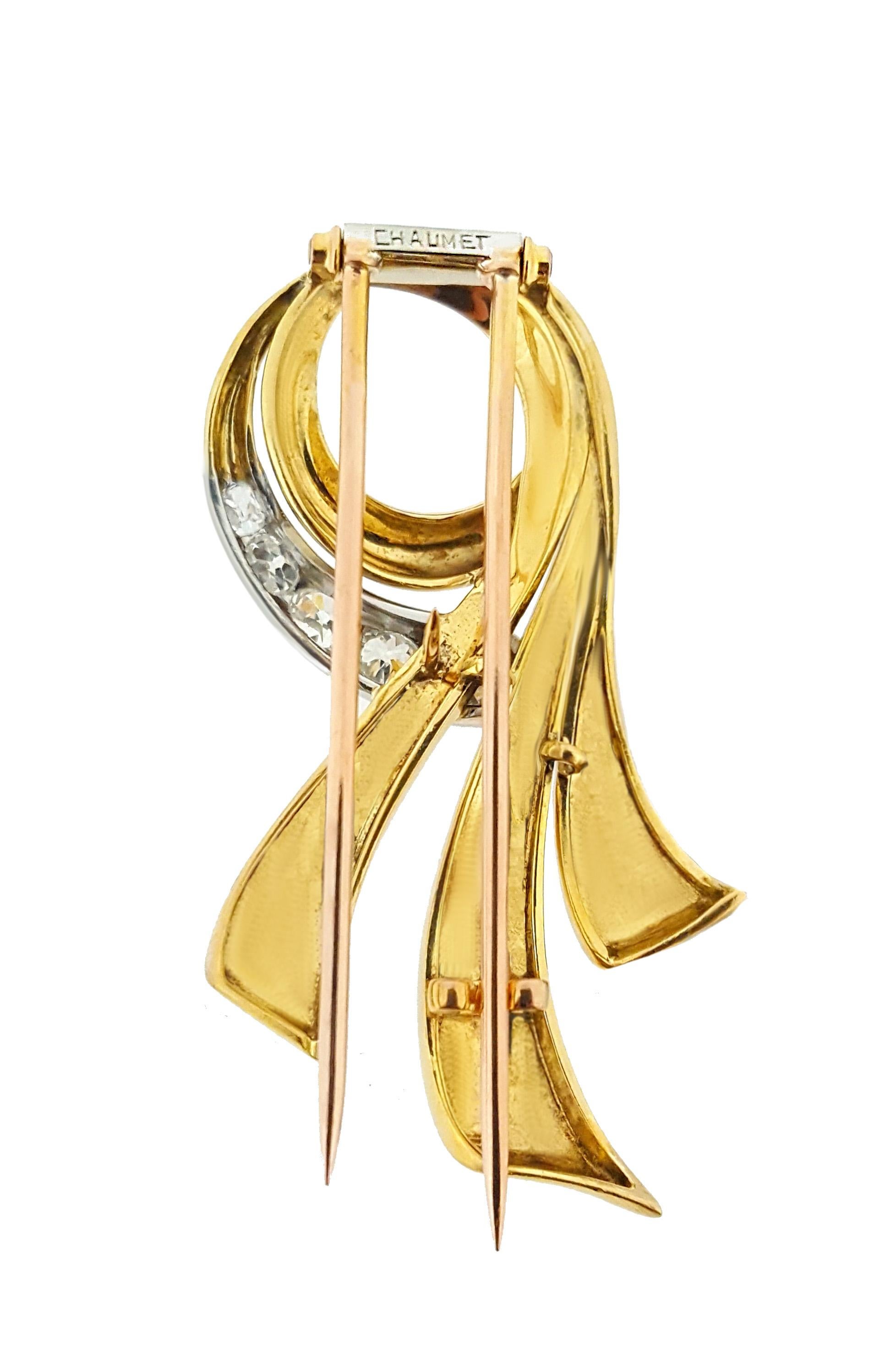 This elegant Chaumet scrolling ribbon brooch features 5 sparkling old mine cut diamonds. The brooch is approximately 2 inches long and 1 inch at its widest point. Stamped and signed 