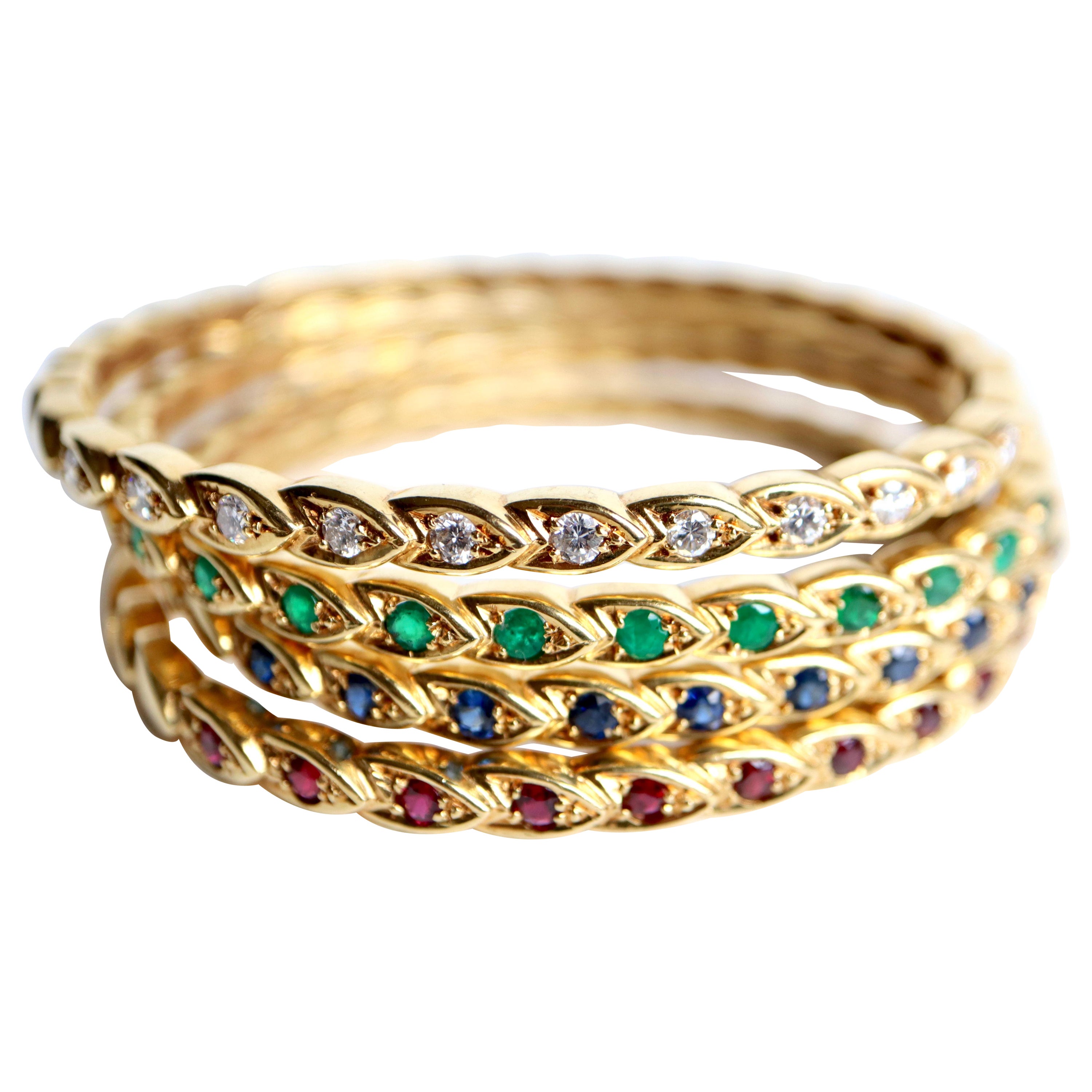 Chaumet 4 bracciali rigidi in oro giallo e pietre preziose