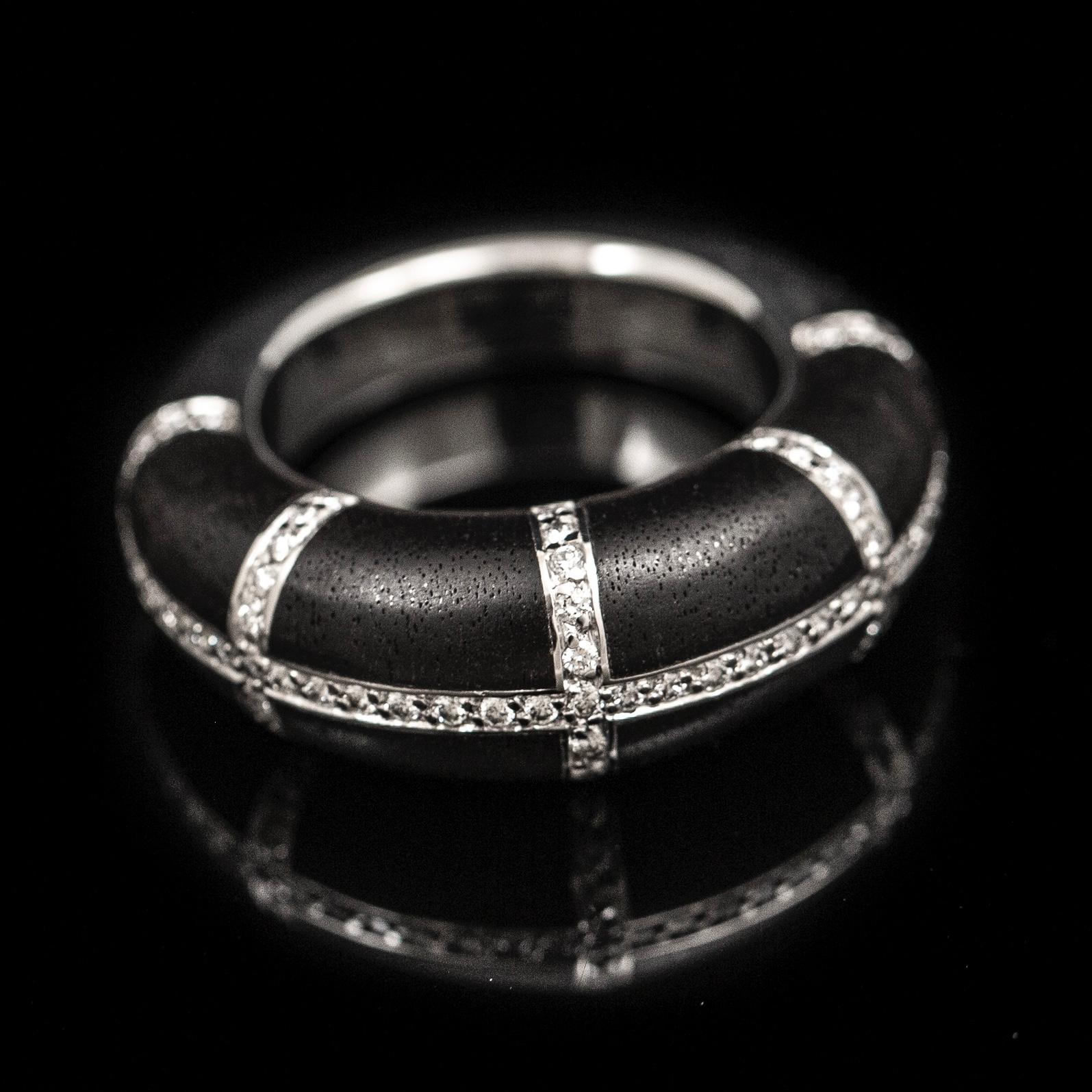 Chaumet “Anneau” diamond and ebony cocktail ring in 18kt white gold, French, vintage from the late 20th century. Of a bombe design, the top part of this ring is composed by ebony plaques divided in eight sections by lines of round brilliant-cut