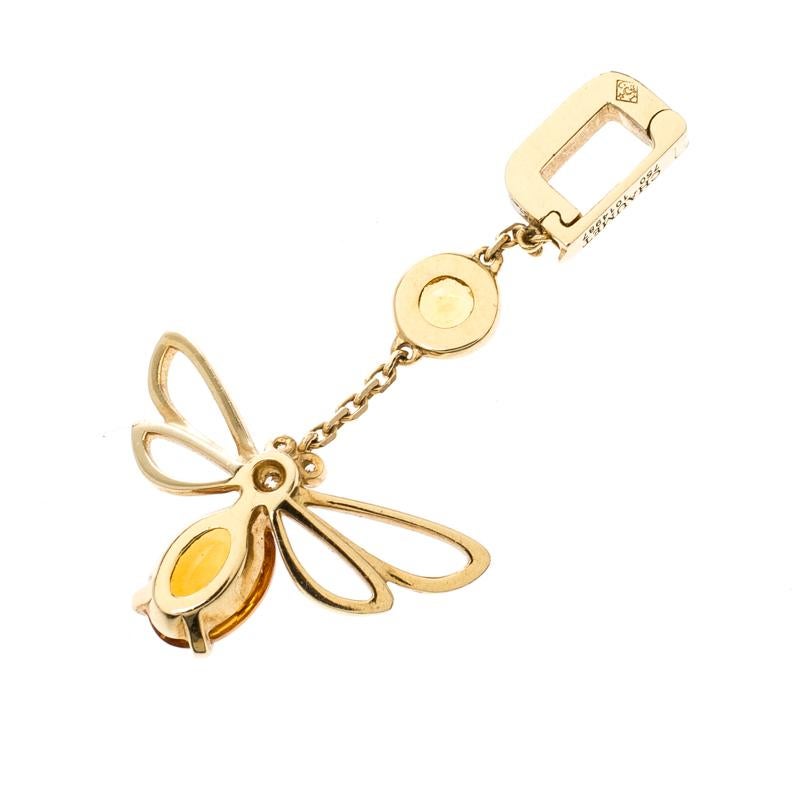 Chaumet's Bee Catch Me if You Love Me charm is graceful and sophisticated. The bee-shaped carving is styled with the citrine gemstone and three diamonds as the face and eyes along with neatly cutout wings. The 18K yellow gold charm comes with a