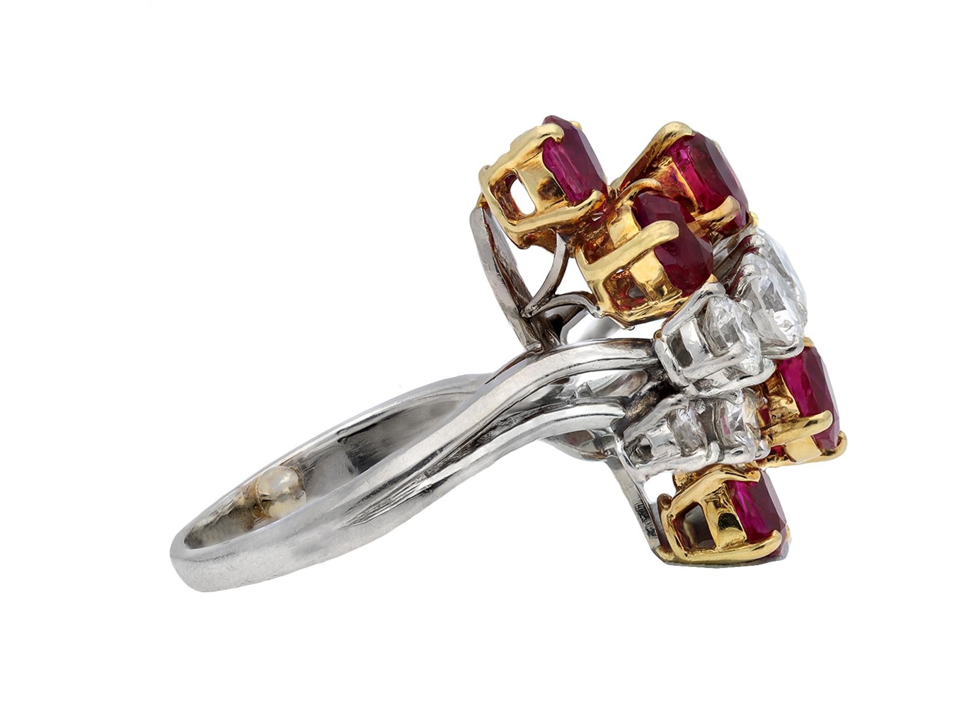 Chaumet Burmese ruby and diamond cluster ring. Set with six oval old cut natural unenhanced Burmese rubies in open back claw settings with a combined approximate weight of 2.50 carats, further set with eight round transitional cut diamonds in open