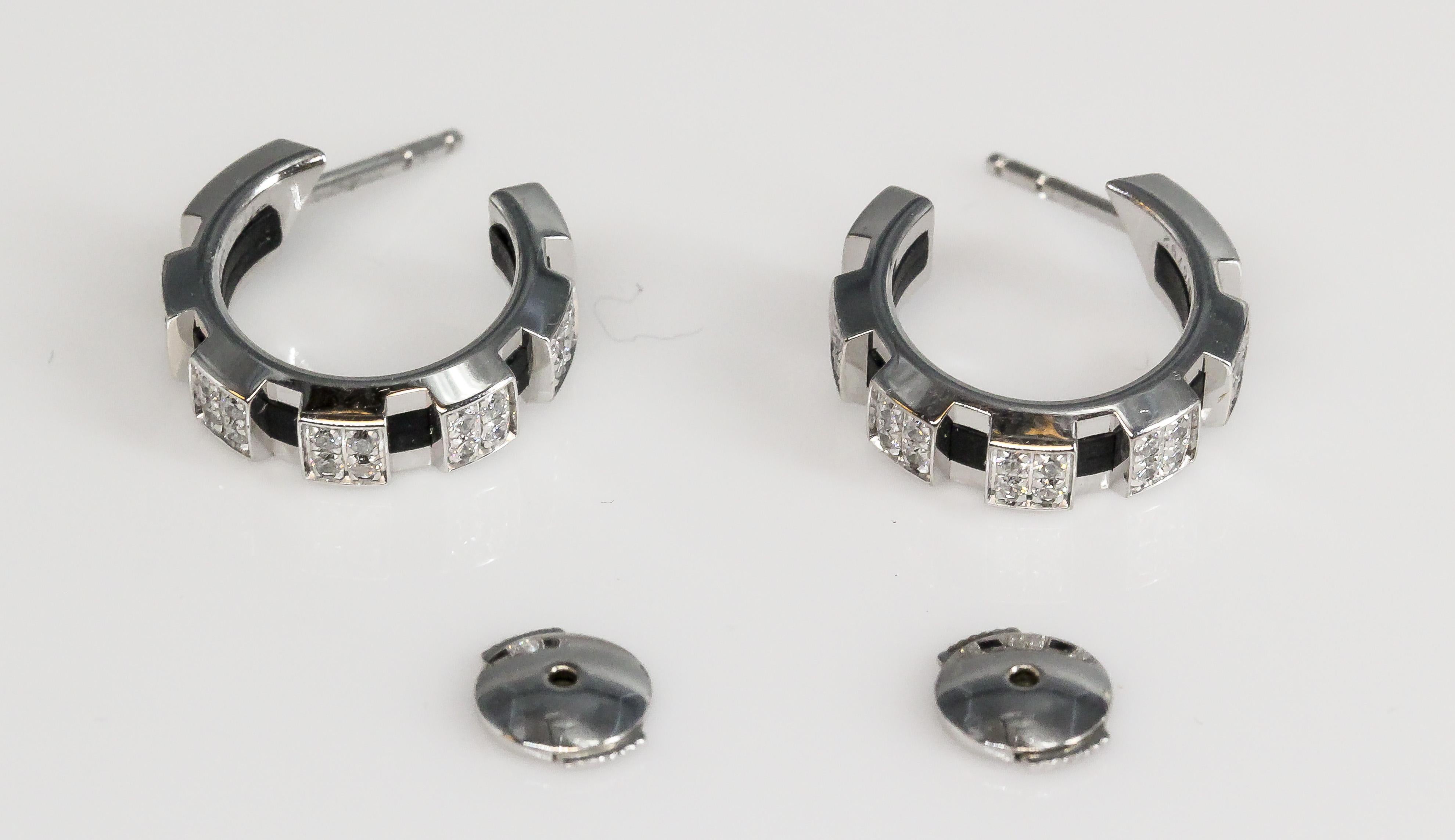 Elevate your style with the contemporary allure of these Chaumet Class One Diamond 18K White Gold Rubber Hoop Earrings. Meticulously crafted, these earrings are a testament to Chaumet's legacy of creating exceptional jewelry that seamlessly combines