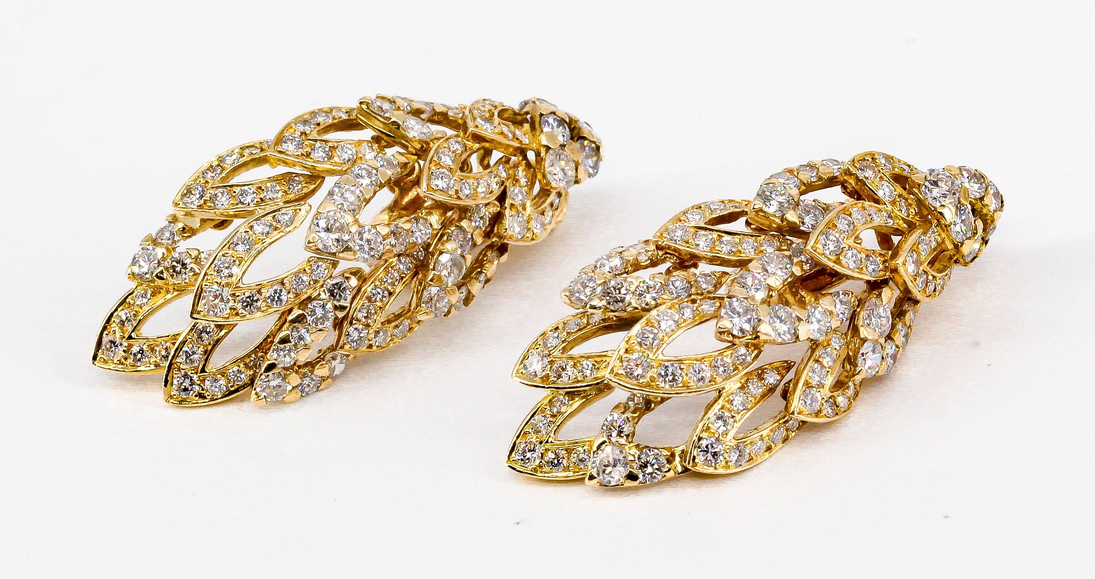 Elegant diamond and 18K yellow gold earrings by Chaumet. They are made in the likeness of wings, with flexible moving parts. Diamonds are high grade round brilliant cut, approx. 5-6 carats total weight,  over a yellow 18K gold setting. 

Hallmarks: