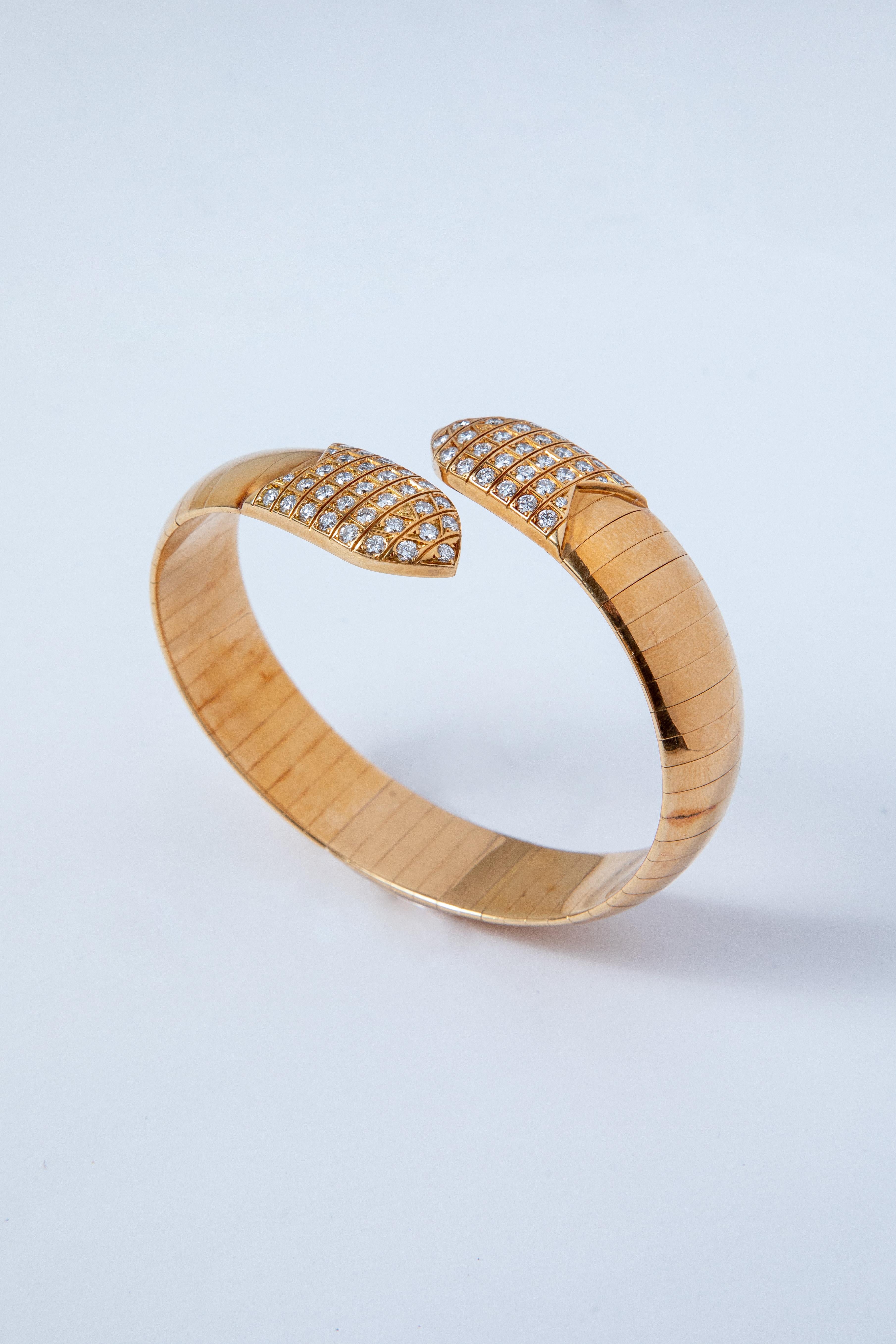 Chaumet Bracelet and Ring made in 18k Yellow Gold set at each end with a grid of brilliant-cut Diamonds

Signed Chaumet Paris and numbered

Wrist circumference: 17.5 cm
Ring size: 5 