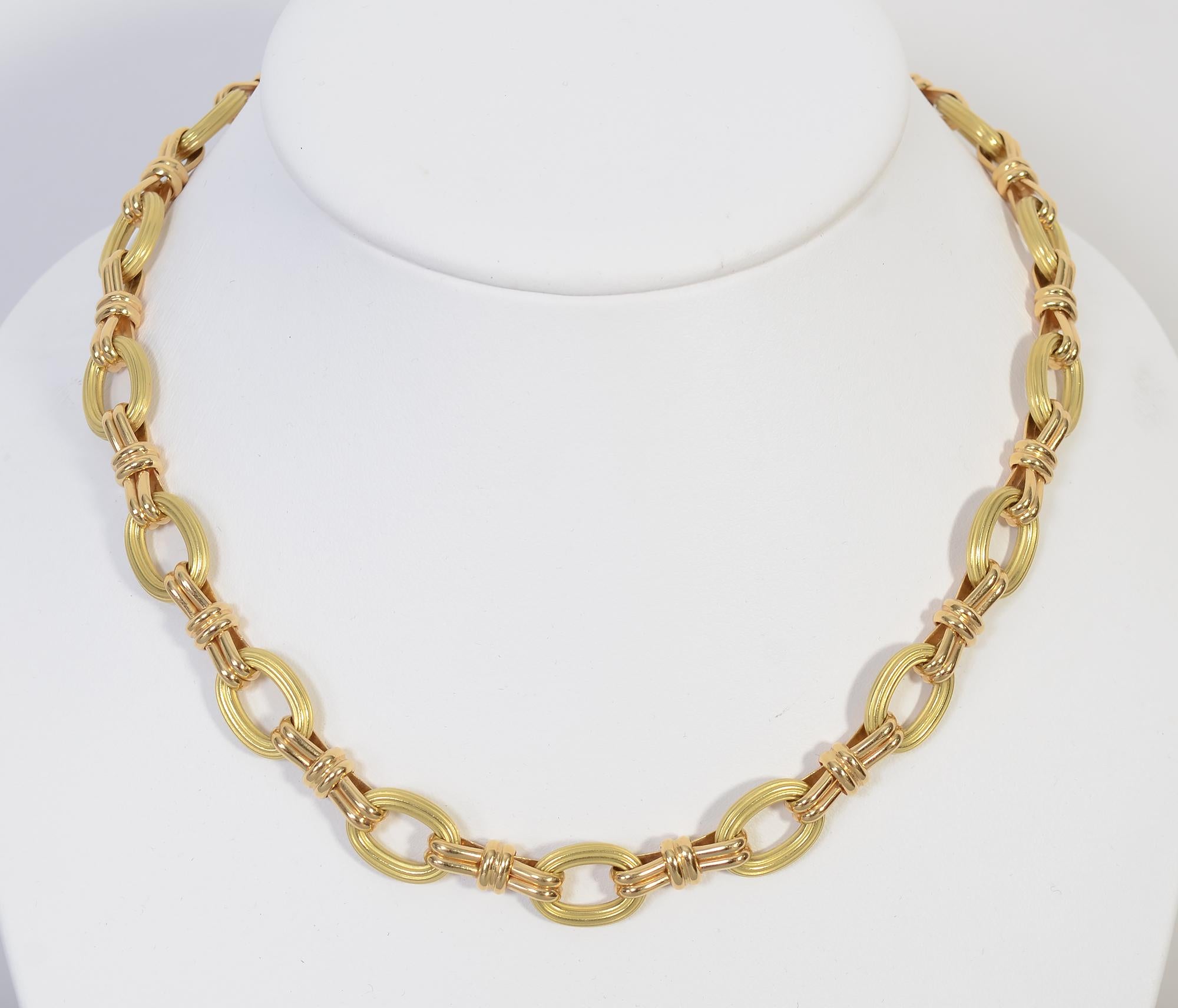 Beautiful and versatile gold links necklace by Chaumet. Ribbed oval links alternate with gloss double loop links. The necklace is 17 1/4 inches in length. The oval loops are 7/16