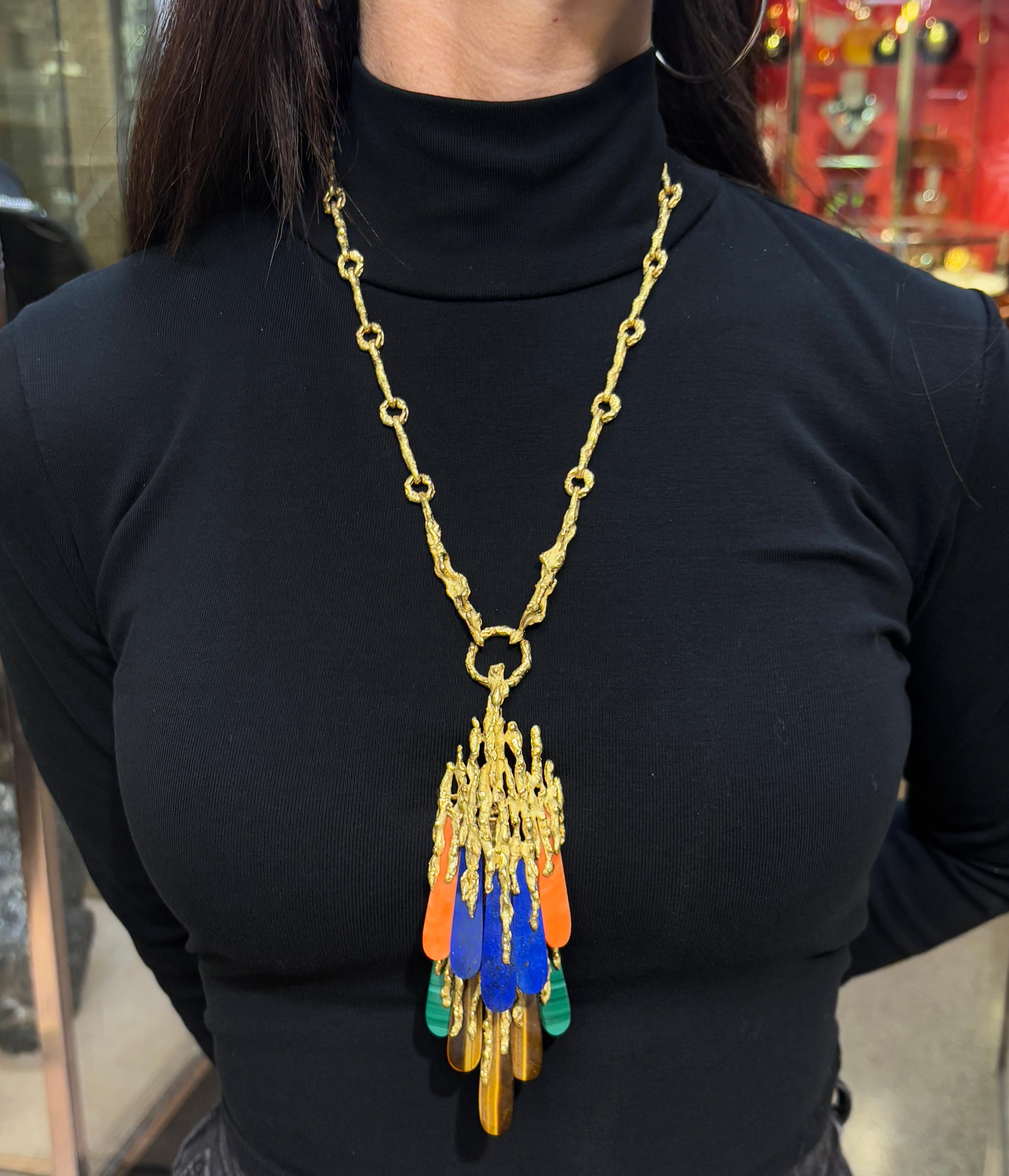 Chaumet Jewelry Suite

A bold yellow-gold multi-stone jewelry suite made by Chaumet. Most likely designed by Pierre Sterle crafted in textured gold and featuring lapis lazuli, coral, malachite, and tiger’s eye. The set includes a long sautoir