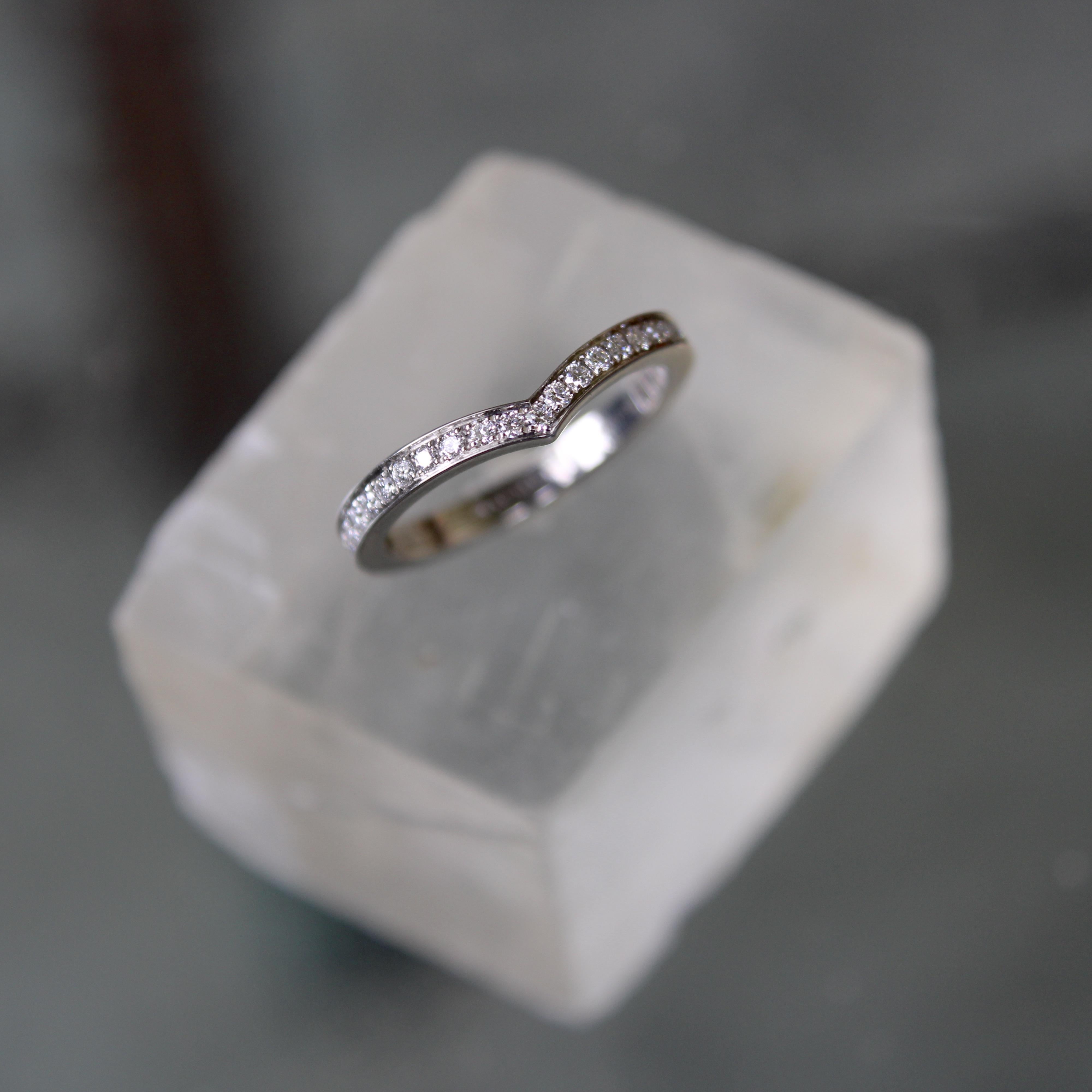 This beautiful Chaumet ring is in current production; this one is in excellent condition. It contains 27 of the highest quality diamonds, bead set in platinum to create a gorgeous line of sparkle. The center of the band makes a chevron coming to a