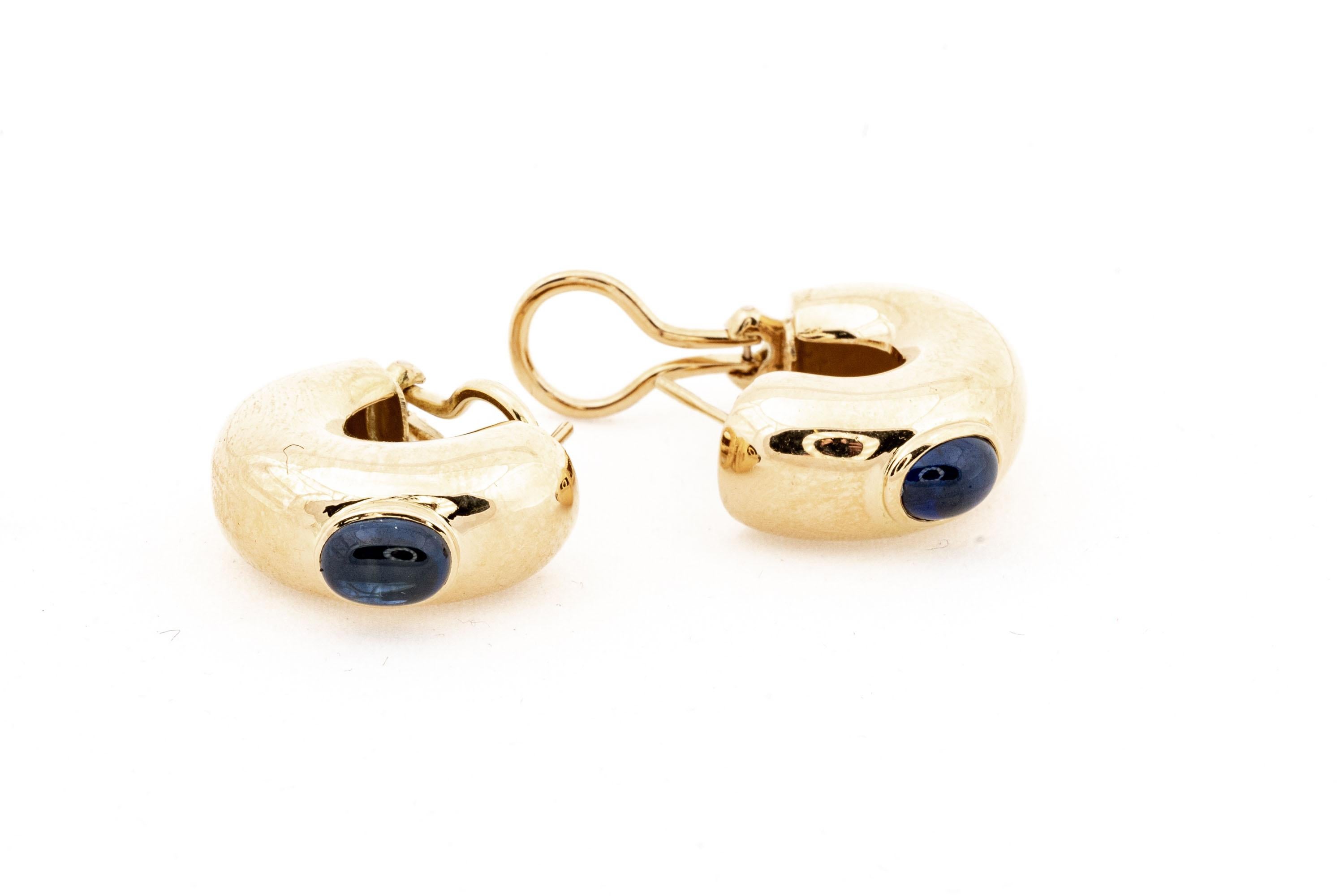 Chaumet Paris 18k yellow gold chunky half hoop earrings. These stunning earrings are from the House of Chaumet (the oldest luxury jeweler still in operation today) and contain one bezel set oval cabachon cut medium/dark blue sapphire each,