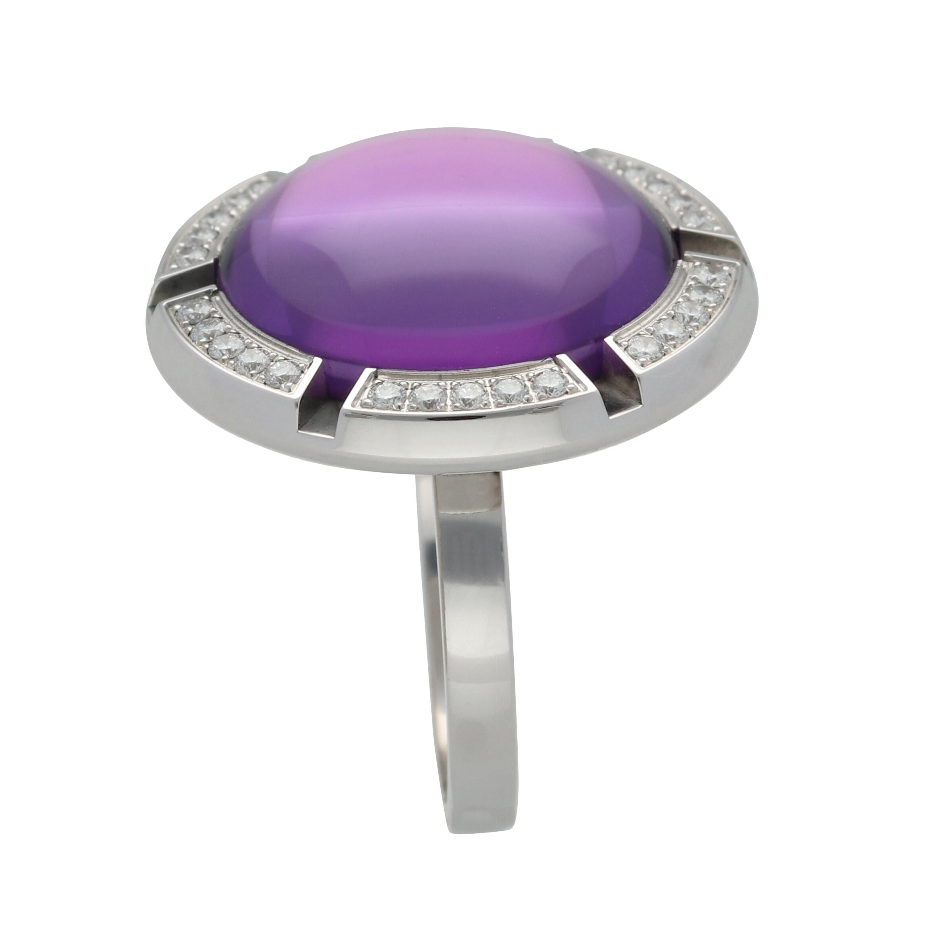 A 750 white gold Chaumet  'Class One Croisière' XL model cocktail ring,  set with a cabochon cut amethyst surrounded by 30 brilliant cut diamonds. 

RING SIZE US 6.5 - 53 mm

Components:
1  Central Amethyst 
Total  Diamonds quantity - 30 
18K white
