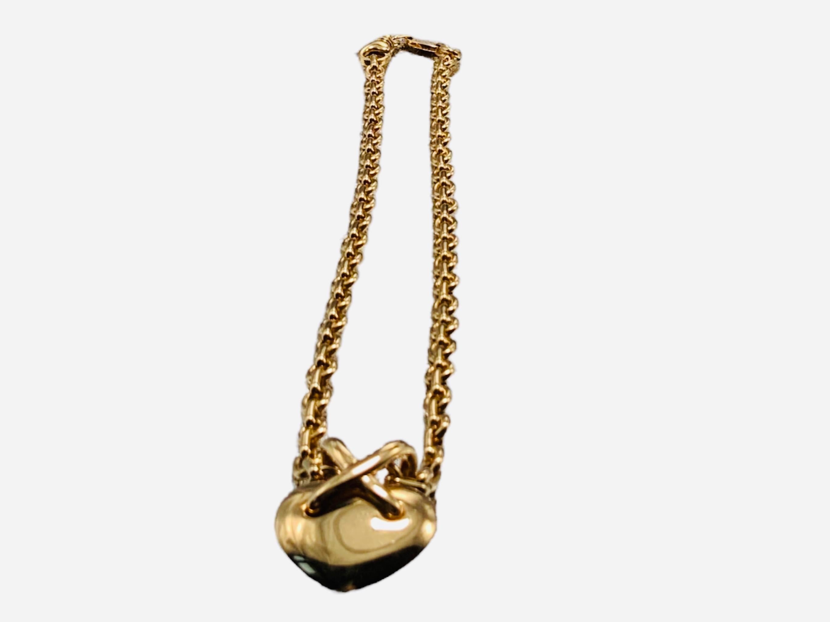 This a 750 (18K gold) Chaumet, Paris Liens Heart necklace. It depicts a gold cable link necklace with heart pendant  that has a large “X” link in the top center. The necklace has a lobster claw clasp closure. Both the necklace and the pendant are