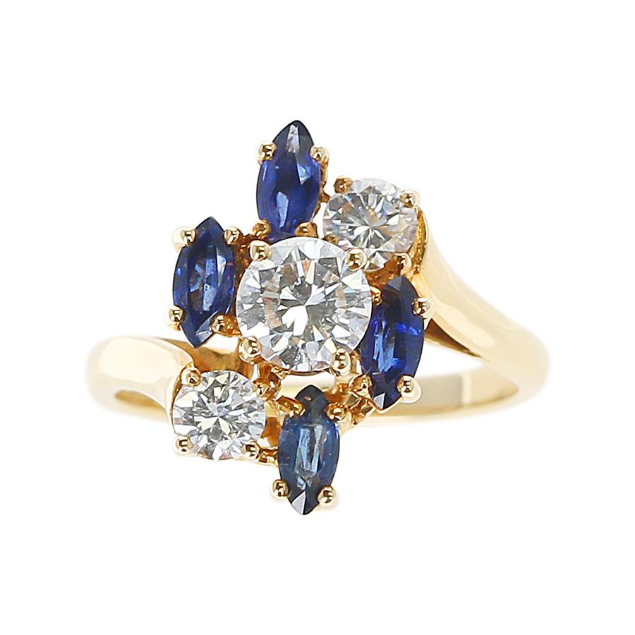 A Chaumet, Paris Marquise Sapphire and Round Diamond Ring,  Center Diamond Weight: 0.60 carats, 2 Side Round Diamonds: 0.25 carats each. 18 Karat Yellow Gold. Total Weight: 4.35 grams, Ring Size US 6.25.