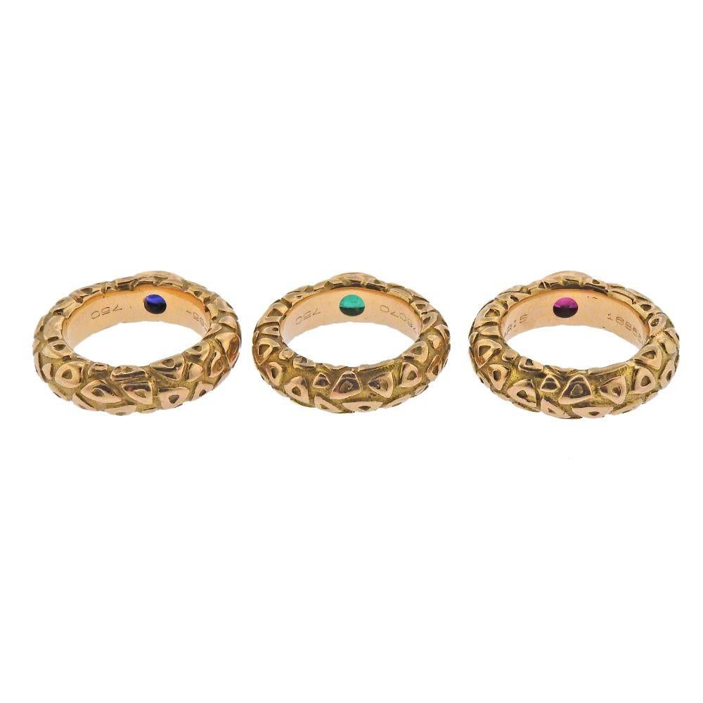 Set of 3 stackable 18k gold band rings by Chaumet Paris, with ruby, emerald and sapphire.   Each ring size - 4.5-4.75, each is 6mm wide. Weight - 26.7 grams. Marked: Chaumet Paris, 176070.