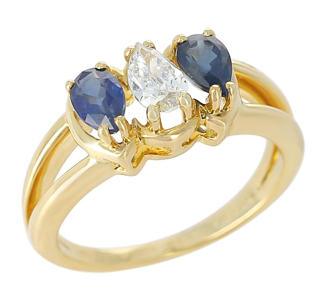 A Chaumet, Paris Ring with a center pear-shape Diamond with two Sapphires on each side. 18 Karat Yellow Gold. Total Weight: 4.36 grams, Ring Size US 5.75.