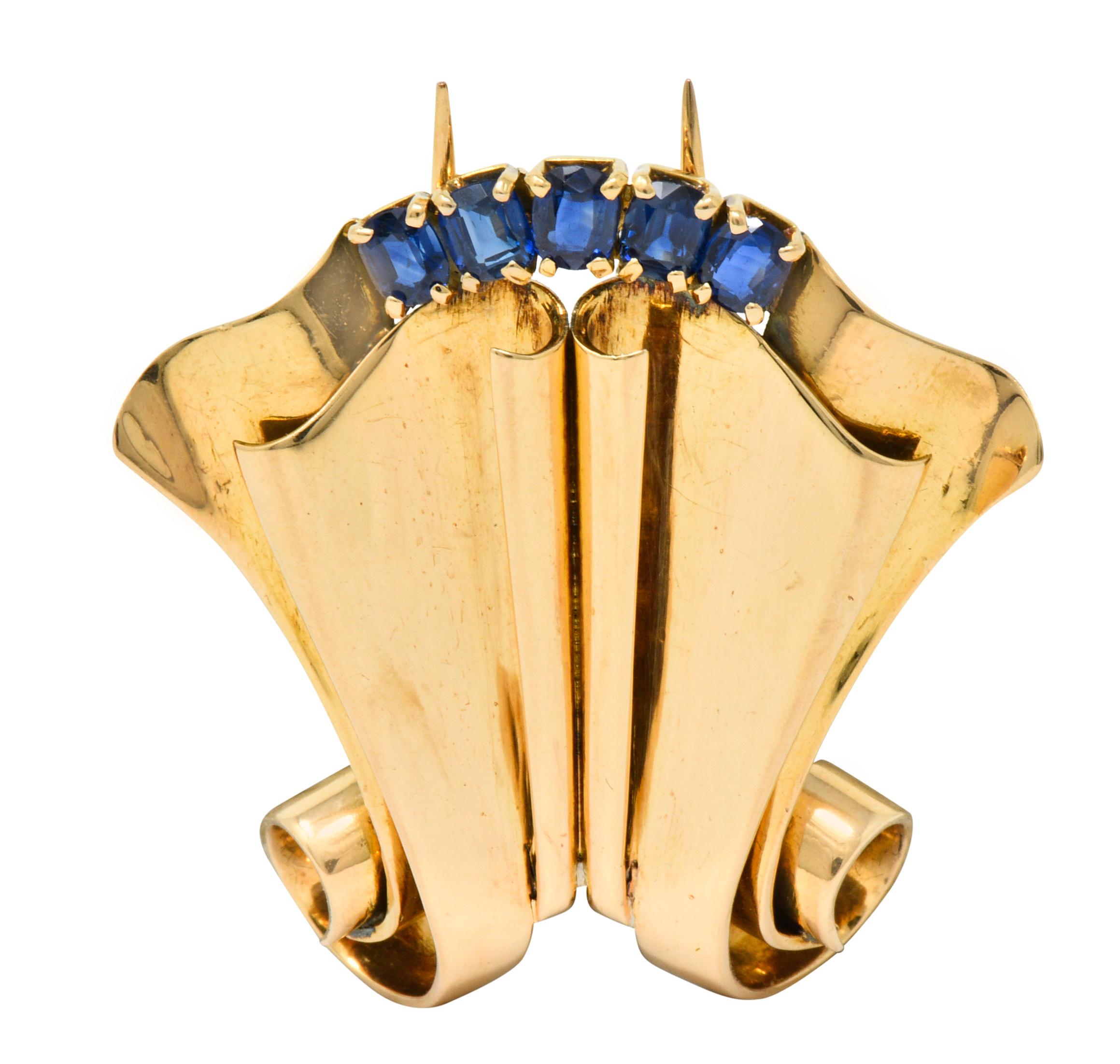 Brooch designed as a beautifully grooved form with scrolled details and scalloped edge

Set with five cushion cut sapphires weighing approximately 1.25 carats total, stunningly royal blue in color

Completed by a bright high polished finish and