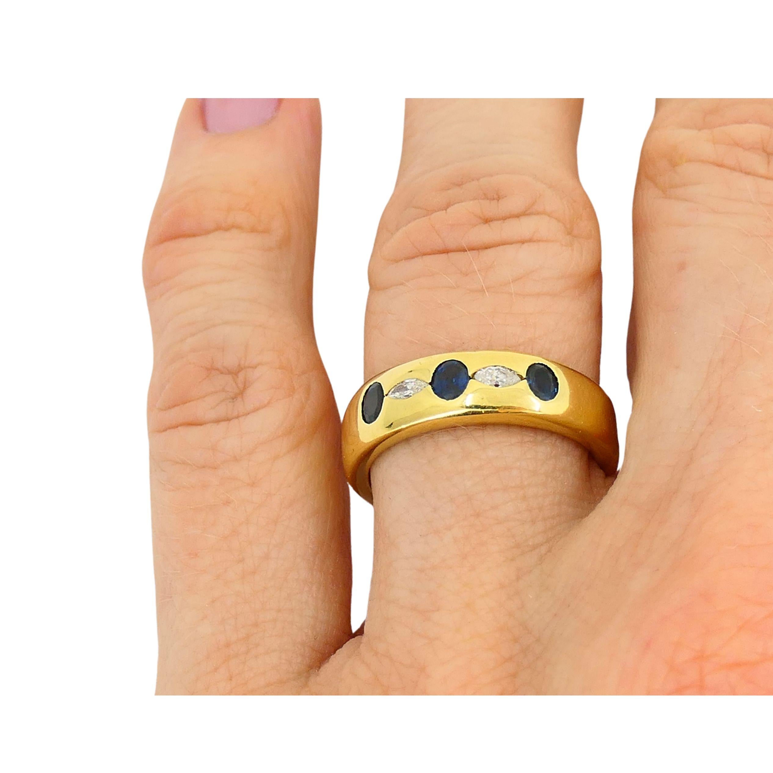 A classic Chaumet band ring, crafted of 18k gold, sapphire, and diamond.
The ring has a refined design that makes it wearable and chic.
Three oval blue sapphires set flush within the band. Nestled between them are two marquise cut diamonds. The mix