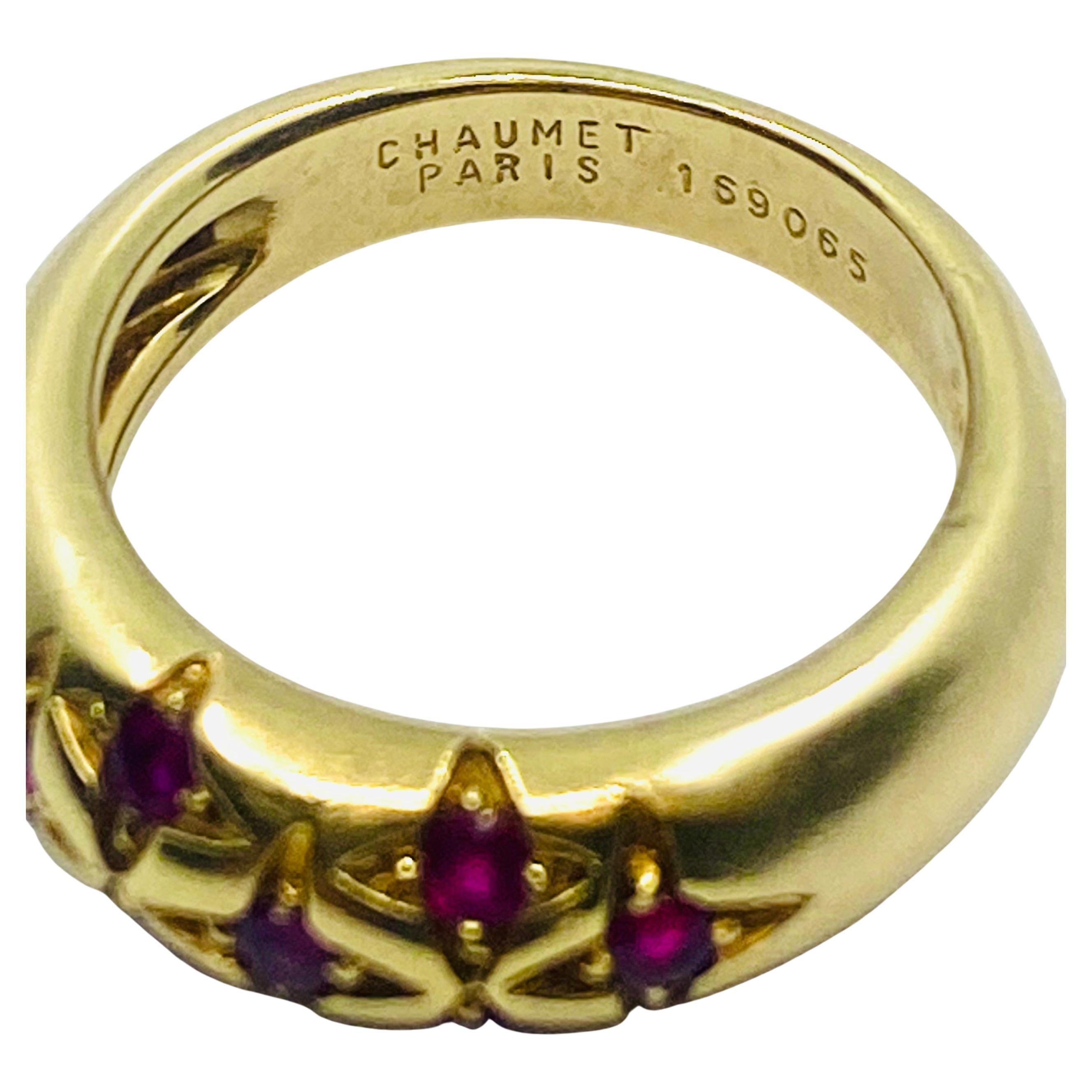 A Chaumet vintage ring made of 18k gold with starry design. The ring is crafted as a domed band with seven stars chiseled in the middle. In the center of each star there are four-prong set cabochon rubies. The gems enhance the look with their vivid