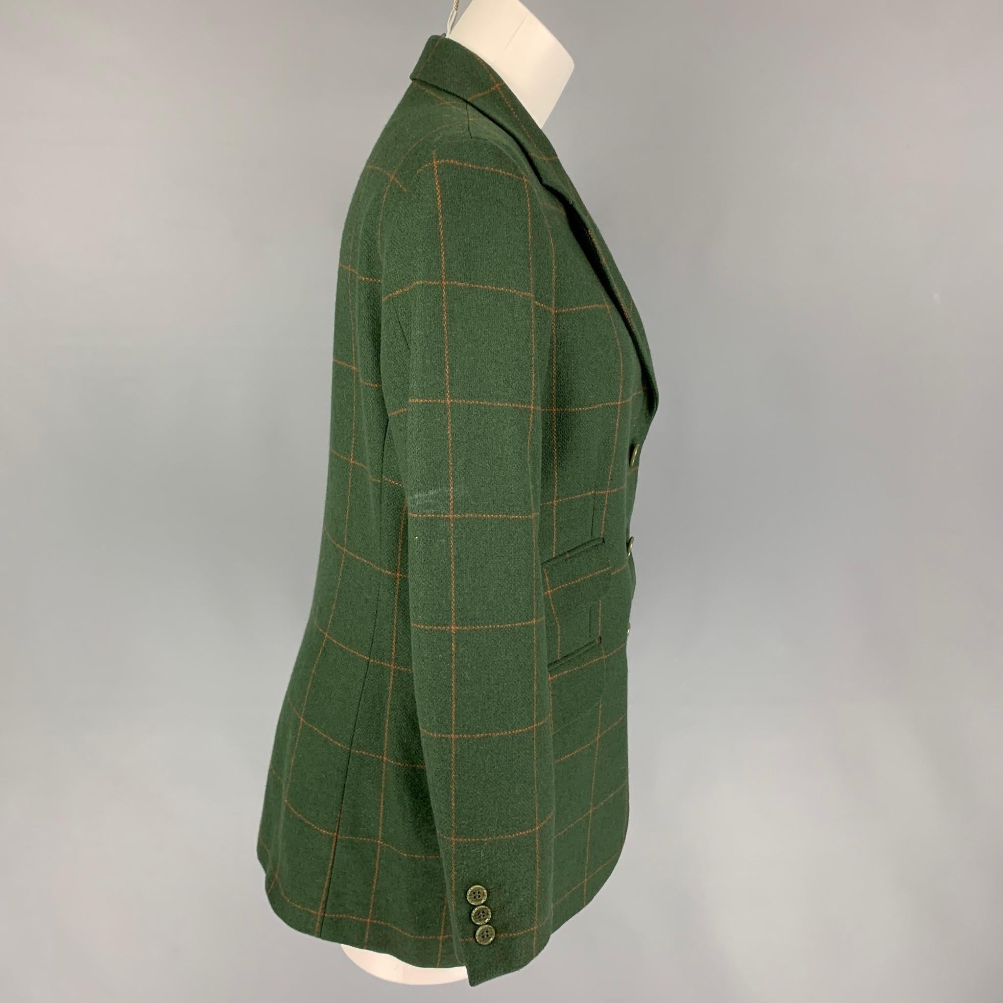CHEAP and CHIC by MOSCHINO blazer comes in a breen & orange windowpane wool with a full liner featuring a notch lapel, flap pockets, single back vent, and a three button closure. Made in Italy.

Very Good Pre-Owned Condition.
Marked: I 44 / D 40   