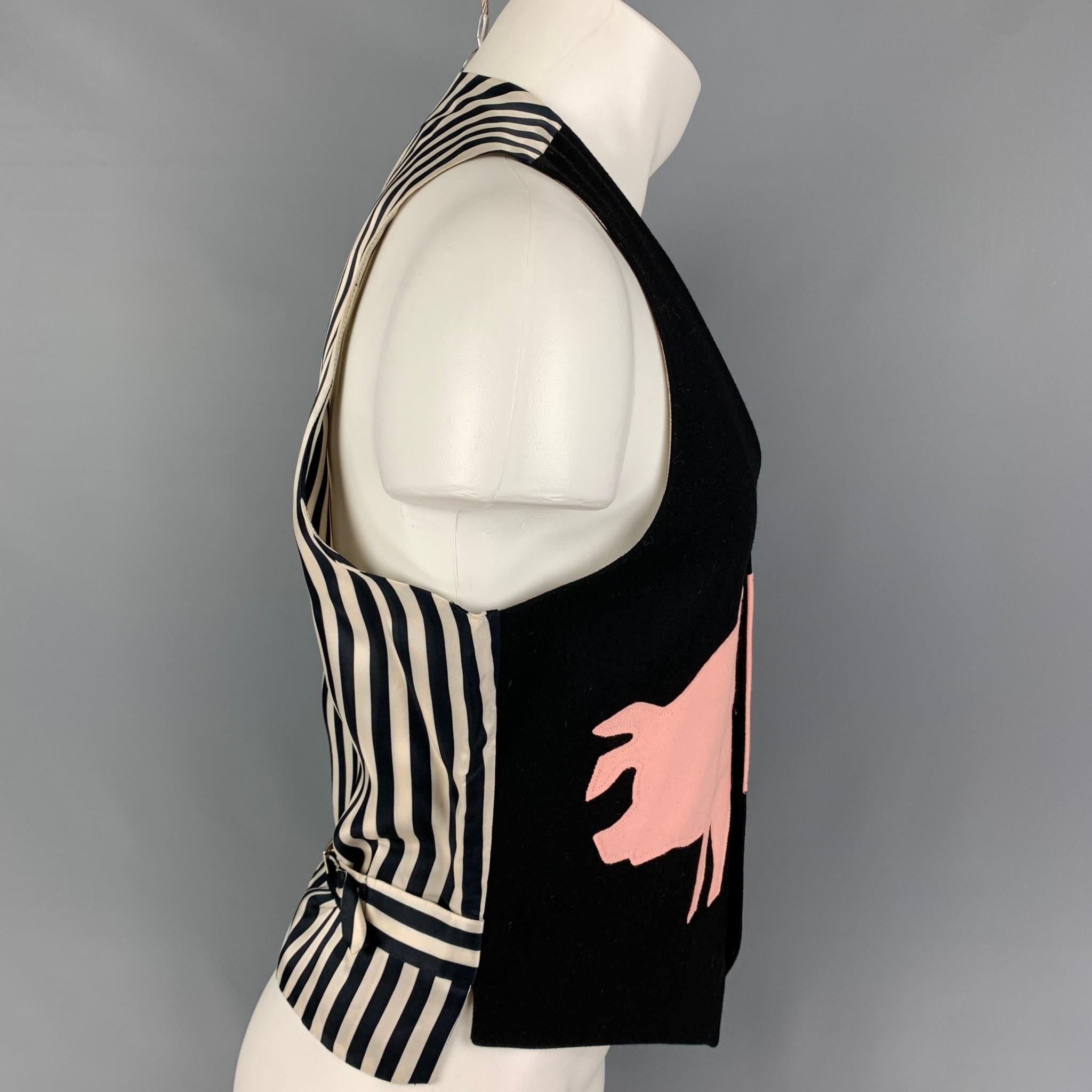Vintage CHEAP an CHIC by MOSCHINO vest comes in a black & white wool / polyamide featuring a striped back, pink applique design, adjustable back strap, and a buttoned closure. Made in Italy. 

Very Good Pre-Owned Condition.
Marked: I 50 / E 50 / GB