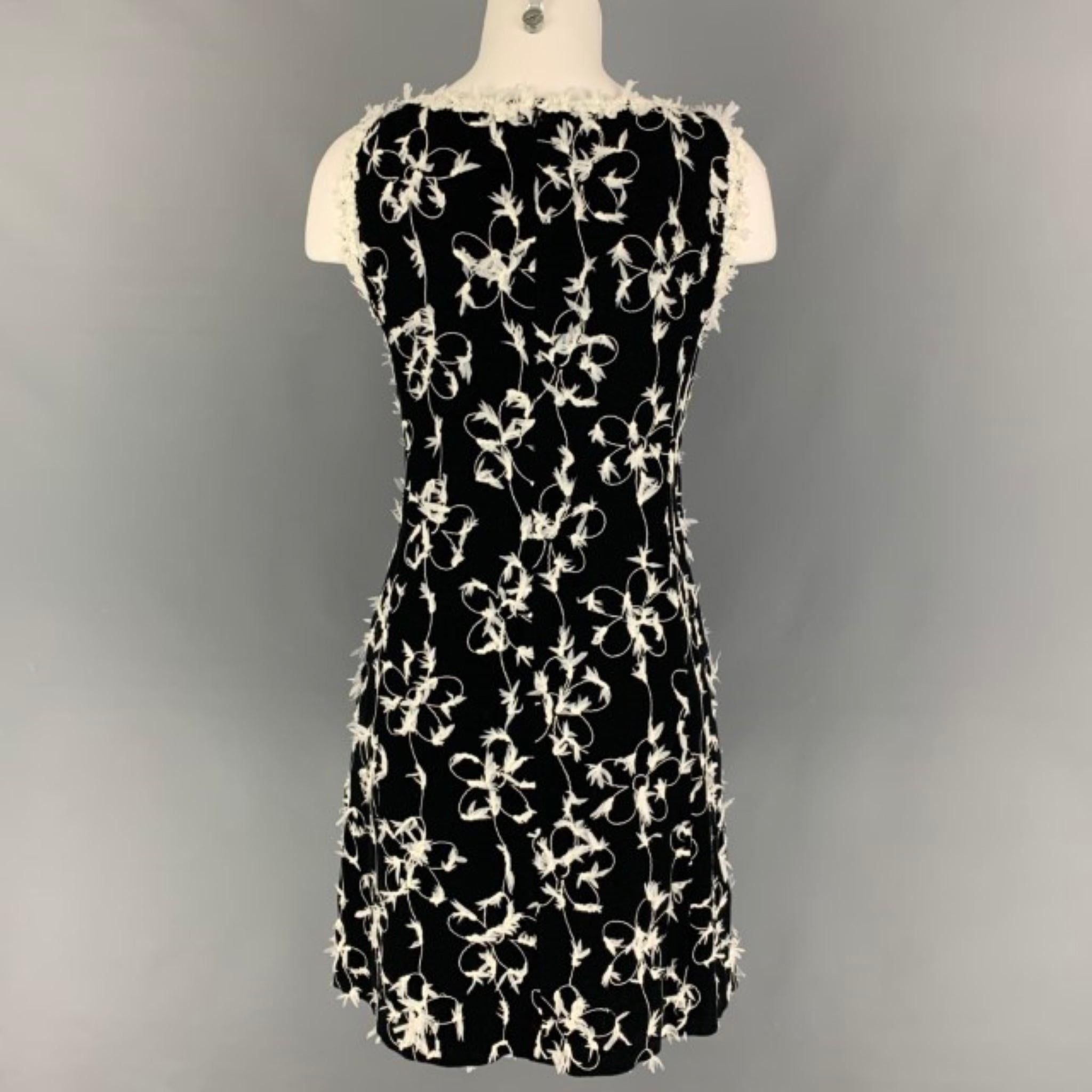 CHEAP and CHIC by MOSCHINO dress comes in a black & white featuring floral embroidered details, sheath style, slit pockets, sleeveless, and a back zipper closure. 

Very Good Pre-Owned Condition.
Marked: I 40 / D 36 / F 36 / GB 8 / USA