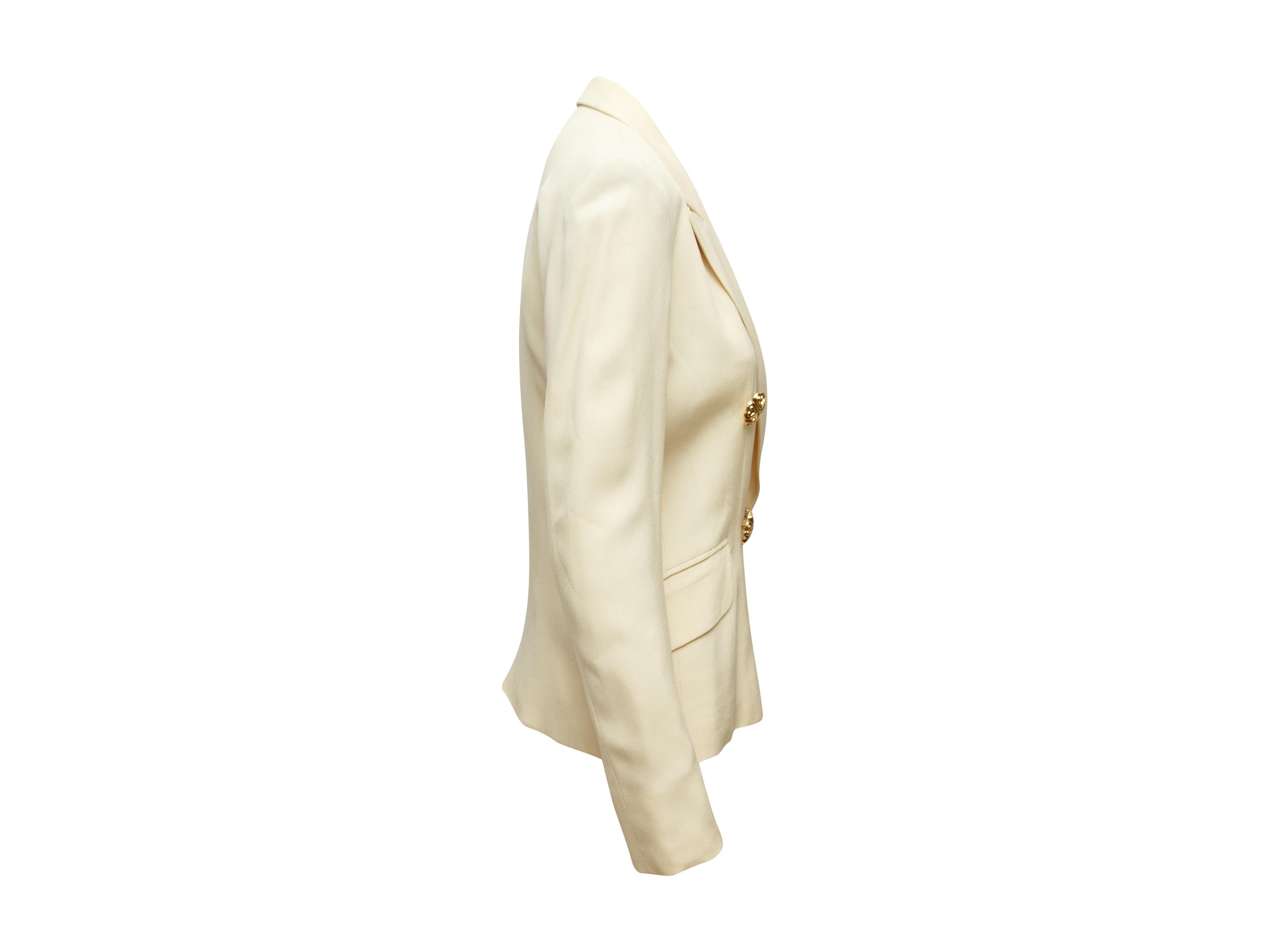 Product details:  Vintage cream double-breasted blazer by Cheap and Chic by Moschino.  Peak lapel.  Long sleeves.  Double-breasted button-front closure.  Waist flap pockets.  Goldtone hardware.  Label size IT 42.  28