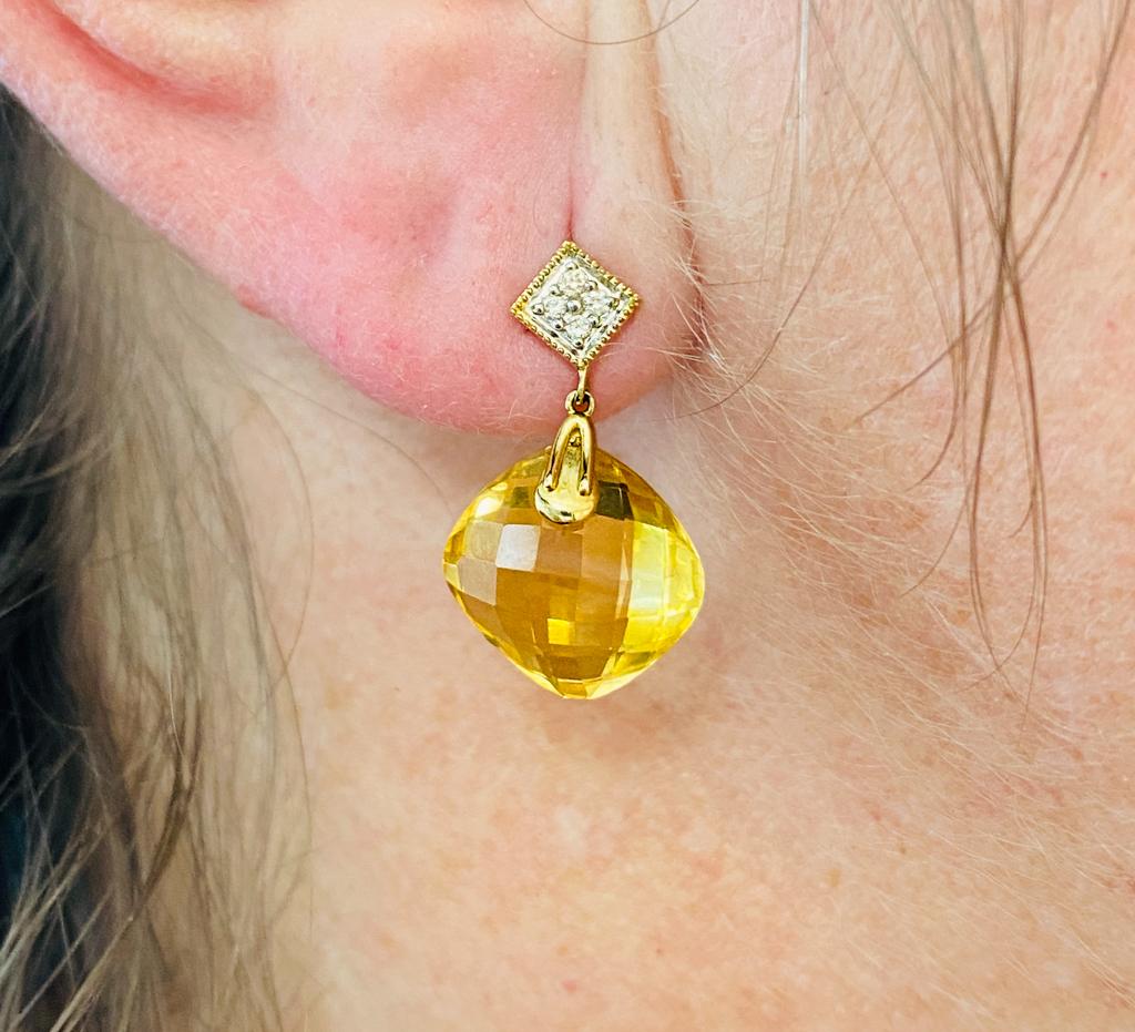 These cheerfully dancing cushion shaped citrines catch lots of light from their checkerboard facets as they suspend on point below the diamond accented earring tops set at the same happy angles as a baseball diamond. The earrings are made in 14