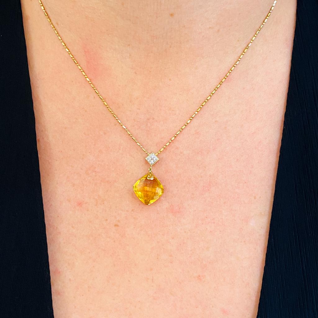 This cheerfully dancing cushion shaped citrine catches lots of light from the checkerboard facets as it suspends on point below the diamond accented top set at the same happy angles as a baseball diamond. The pendant and chain is made in 14 karat